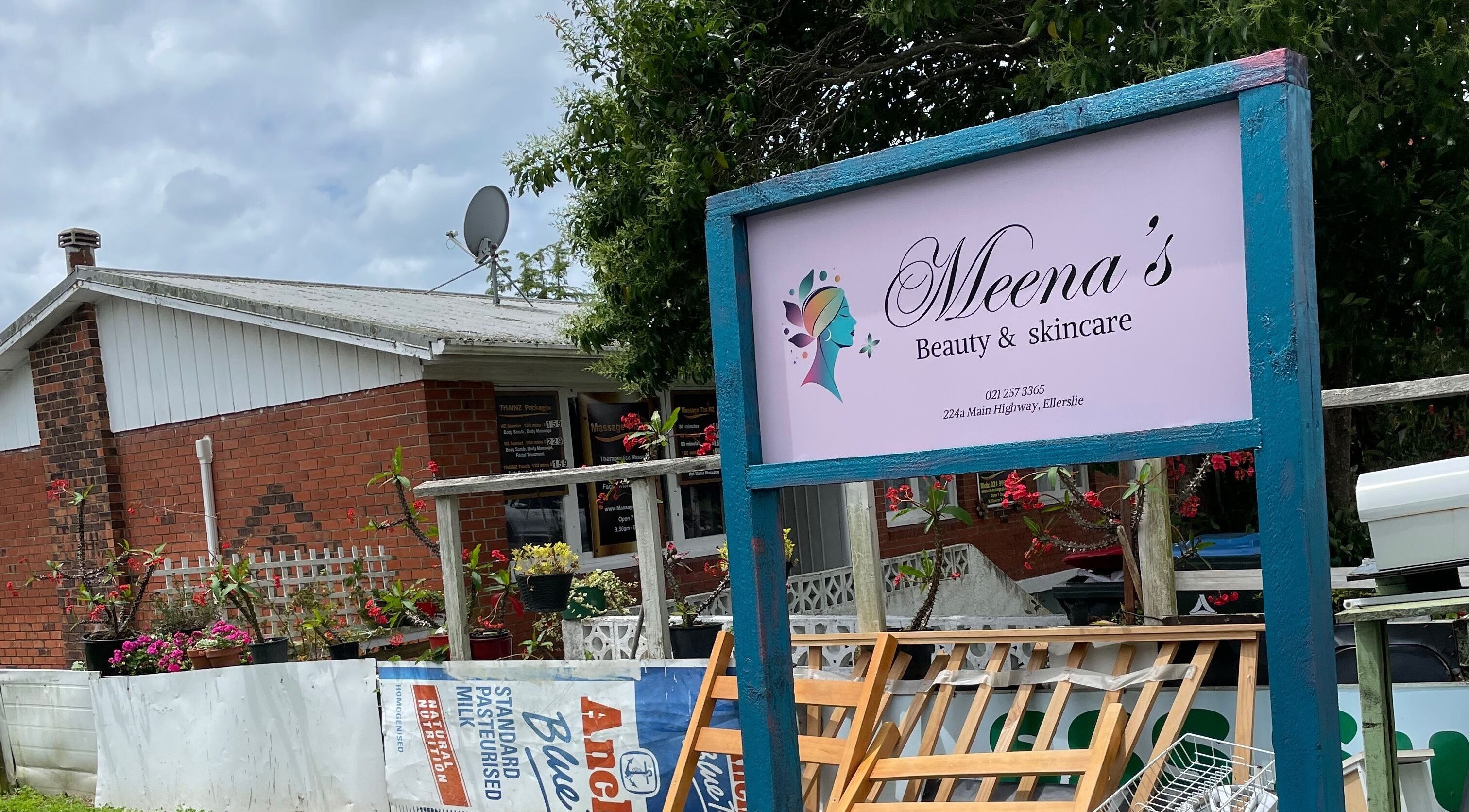Welcoming entrance sign at Meena’s Beauty & Skincare in Auckland, Auckland, NZ with colorful flowers.
