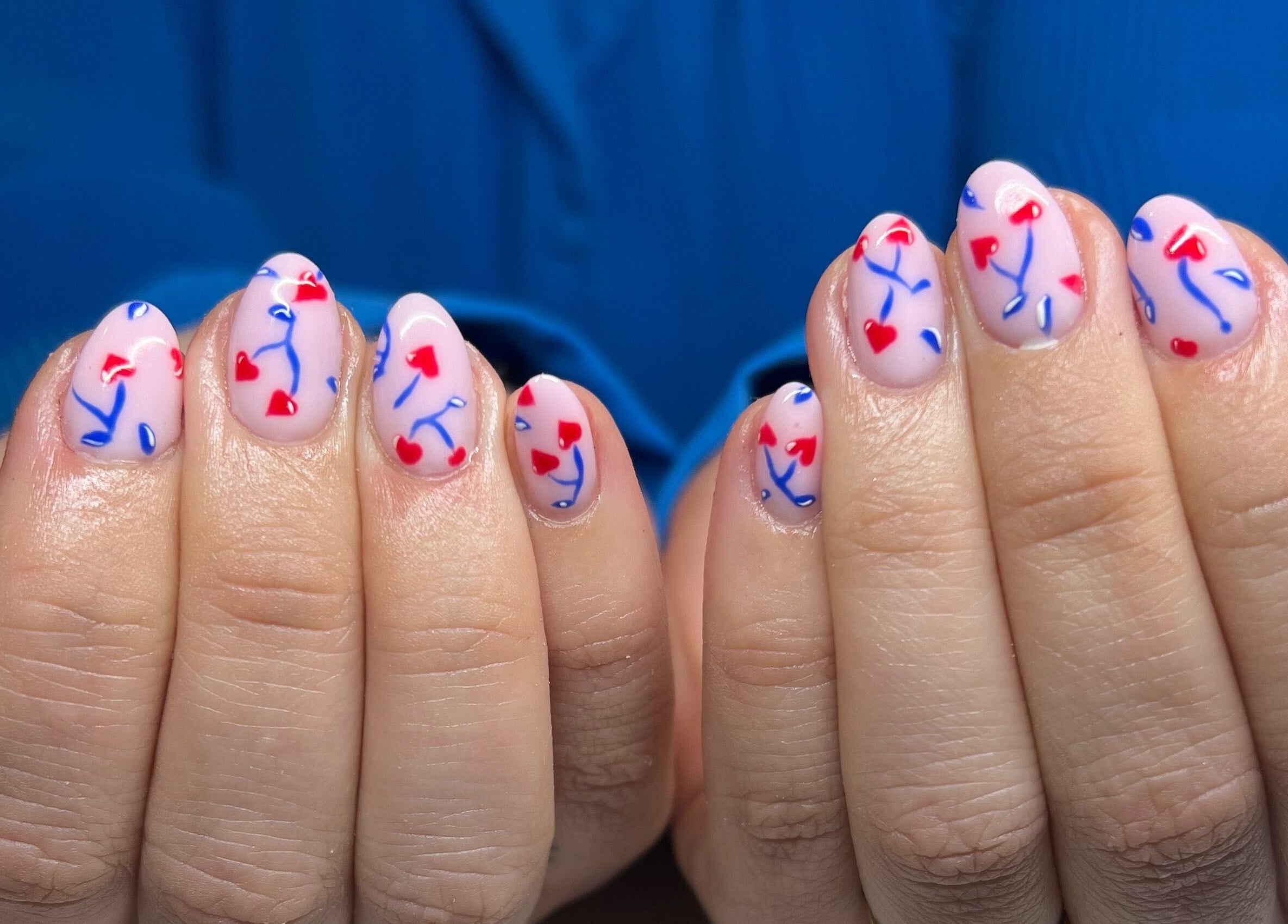 Heart art nails design with red and blue at Nails by Layla, Sherford, England, GB.