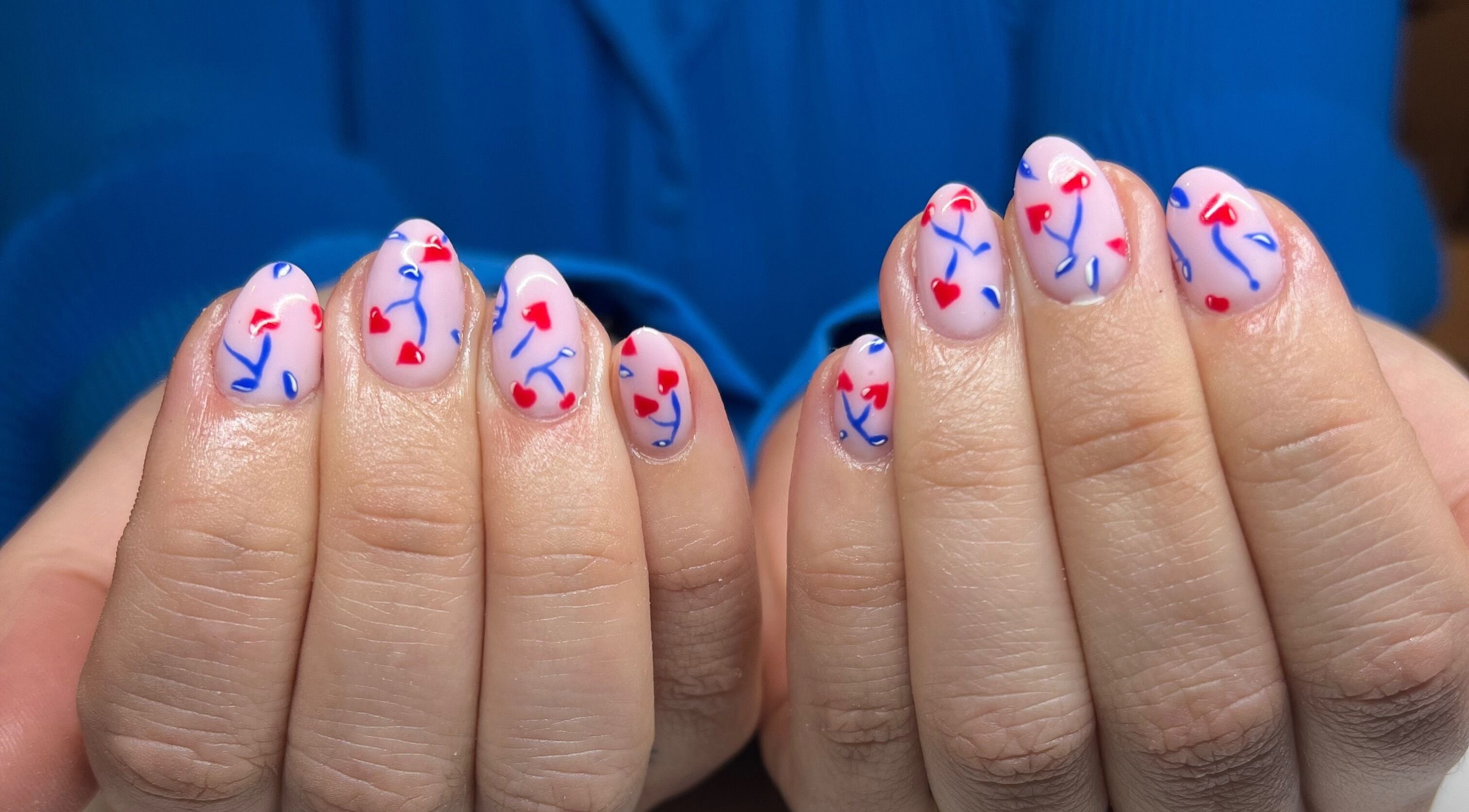 Heart art nails design with red and blue at Nails by Layla, Sherford, England, GB.