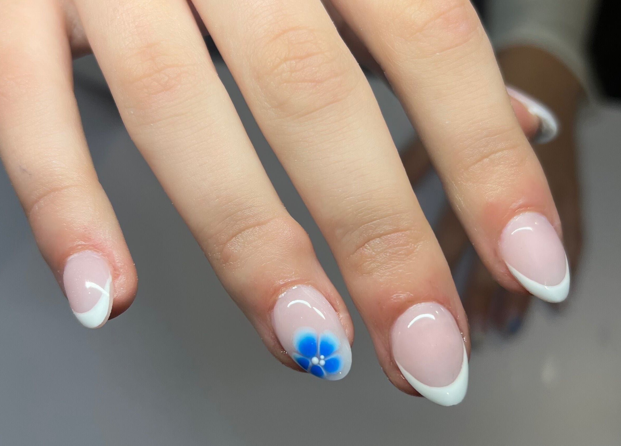 Nail art with blue floral design at Nails by Layla in Sherford, England, GB.