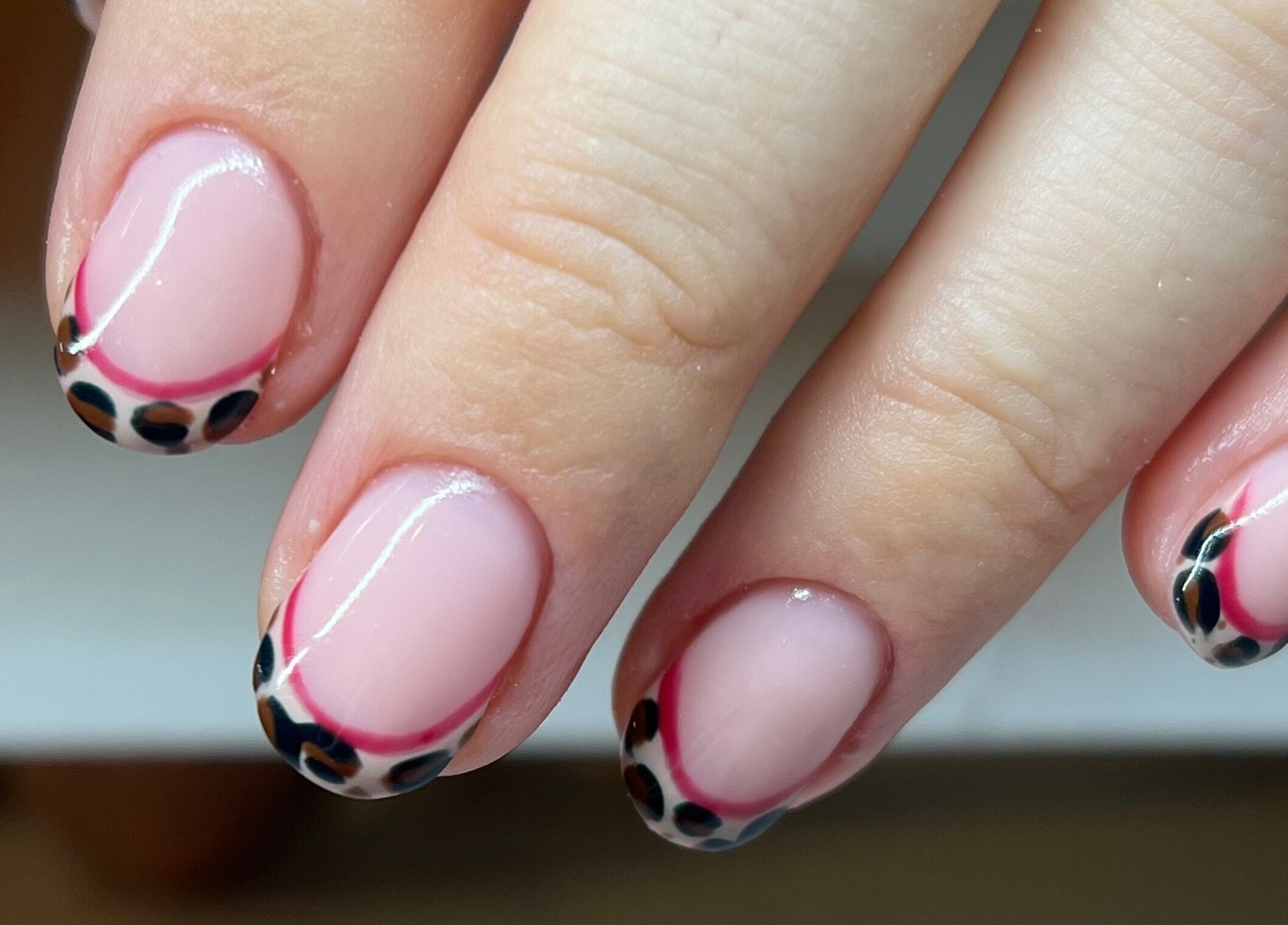 Stylish nail art with pink and black accents by Nails by Layla, Sherford, England, GB.