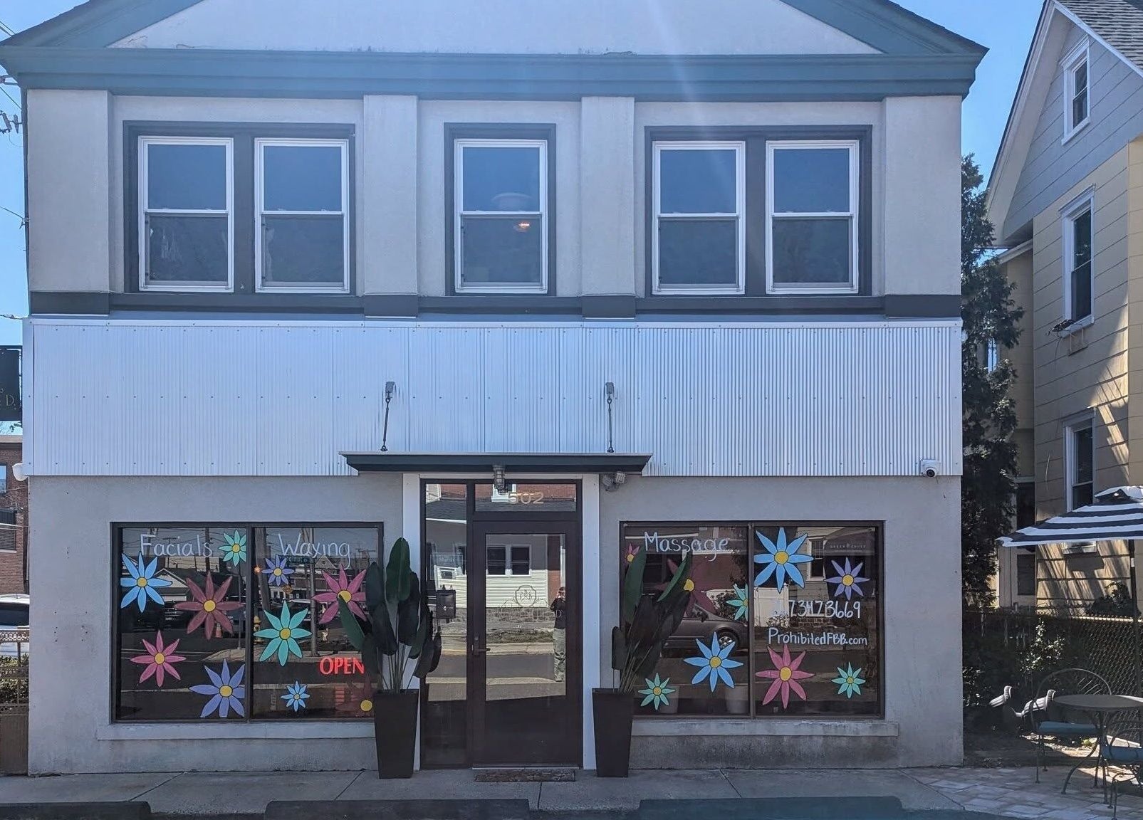 Front view of Prohibited Face and Body Bar in Quakertown, Pennsylvania, US, showcasing colorful window decor.