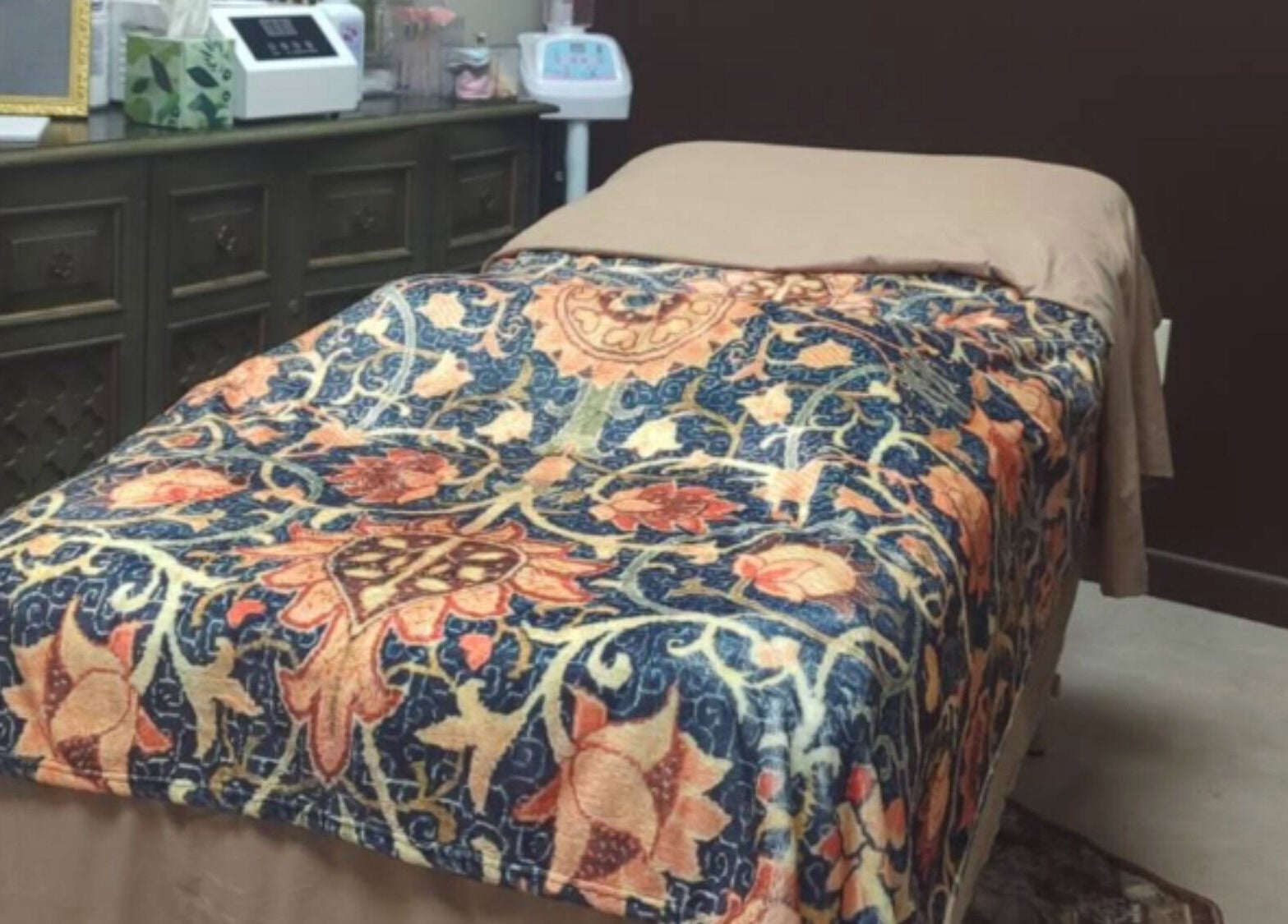Inviting treatment room at Prohibited Face and Body Bar, Quakertown, Pennsylvania, US with ornate blanket.