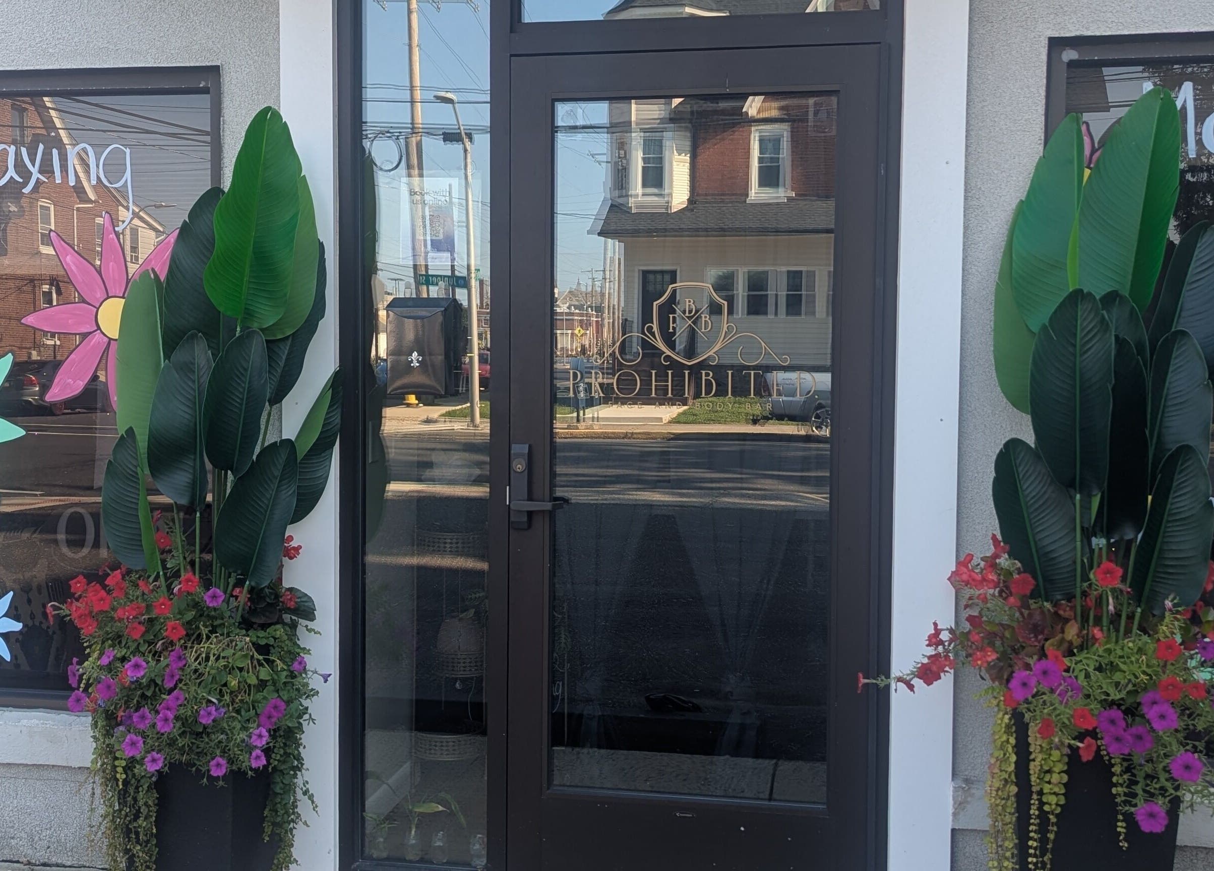 Prohibited Face and Body Bar entrance with bright flowers in Quakertown, Pennsylvania, US.