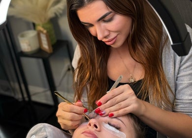 Lash artist expertly applying lashes at Lash Brow Room, Johns Creek, Georgia, US.
