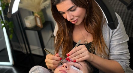 Lash artist expertly applying lashes at Lash Brow Room, Johns Creek, Georgia, US.