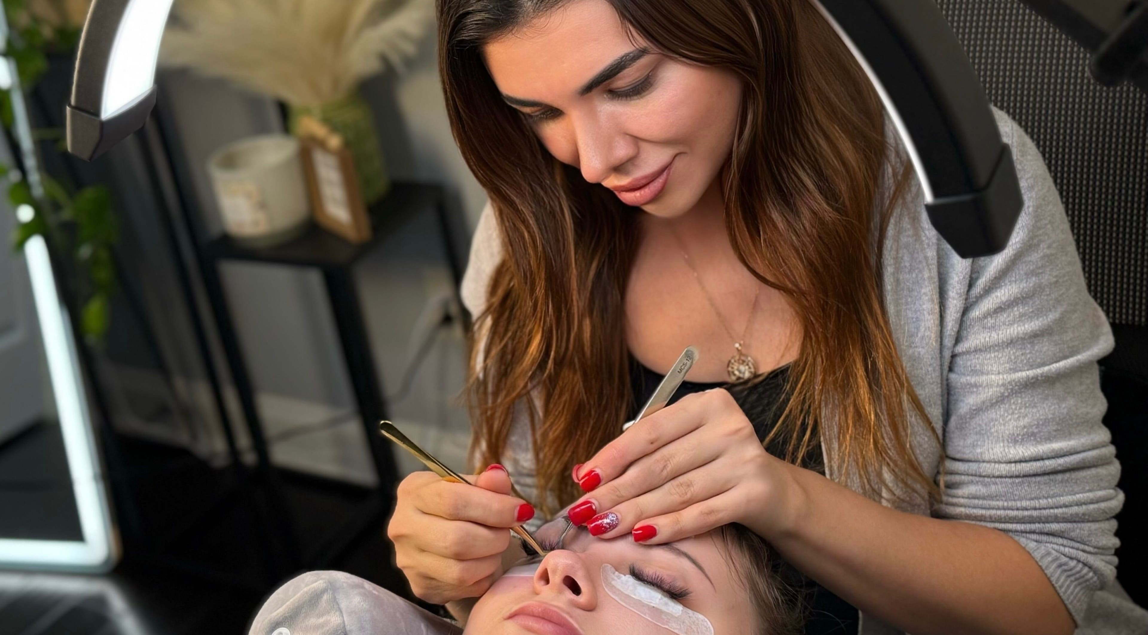 Expert lash application at Lash Brow Room, Johns Creek, Georgia, US showcasing precise beauty techniques.