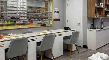 Stylish nail salon interior at Top Nail And Beauty, London, England, GB with elegant seating and polish display.
