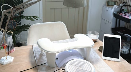 Nail station setup at Lilliegracebeauty, Wellington, GB, featuring a nail lamp, tablet, and chic decor.
