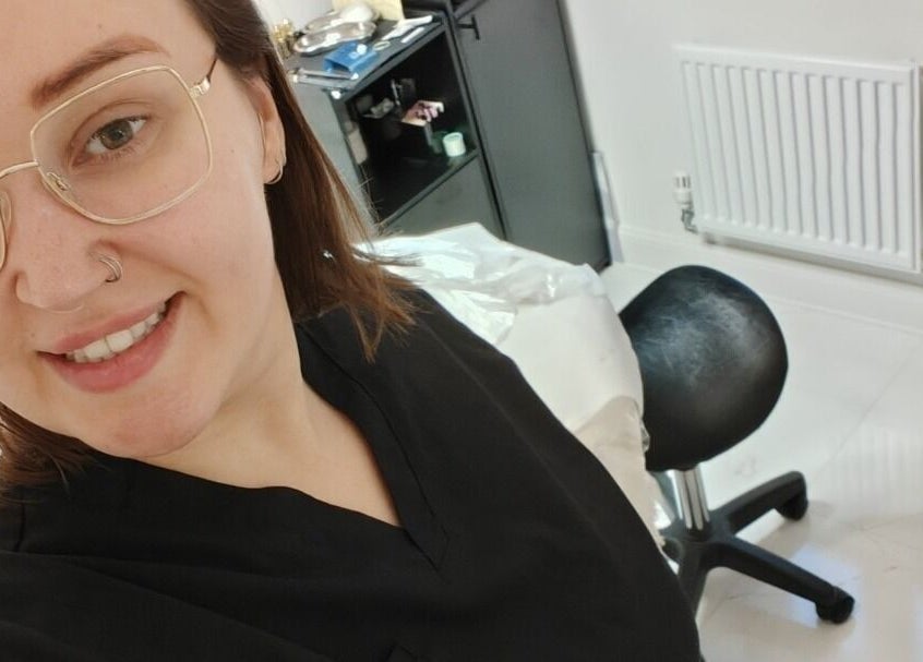 Professional smiling at Coffee Brows and Beauty, Ashford, England, GB, inside a modern treatment room.