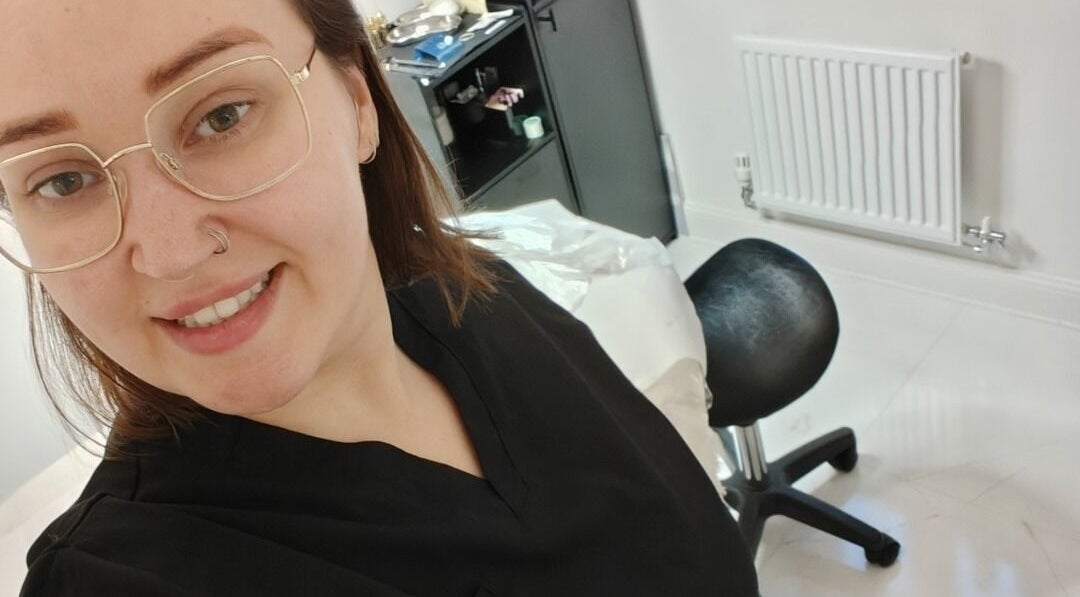 Professional smiling at Coffee Brows and Beauty, Ashford, England, GB, inside a modern treatment room.
