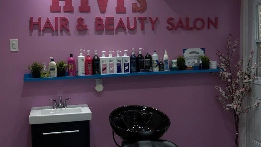 Hivi's Hair & Beauty Salon in Hamilton, Ontario, CA features a stylish wash station with vibrant decor.