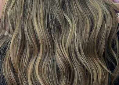 Styled wavy blonde hair at Hivi's Hair & Beauty Salon, Hamilton, Ontario, CA for a luxurious look.