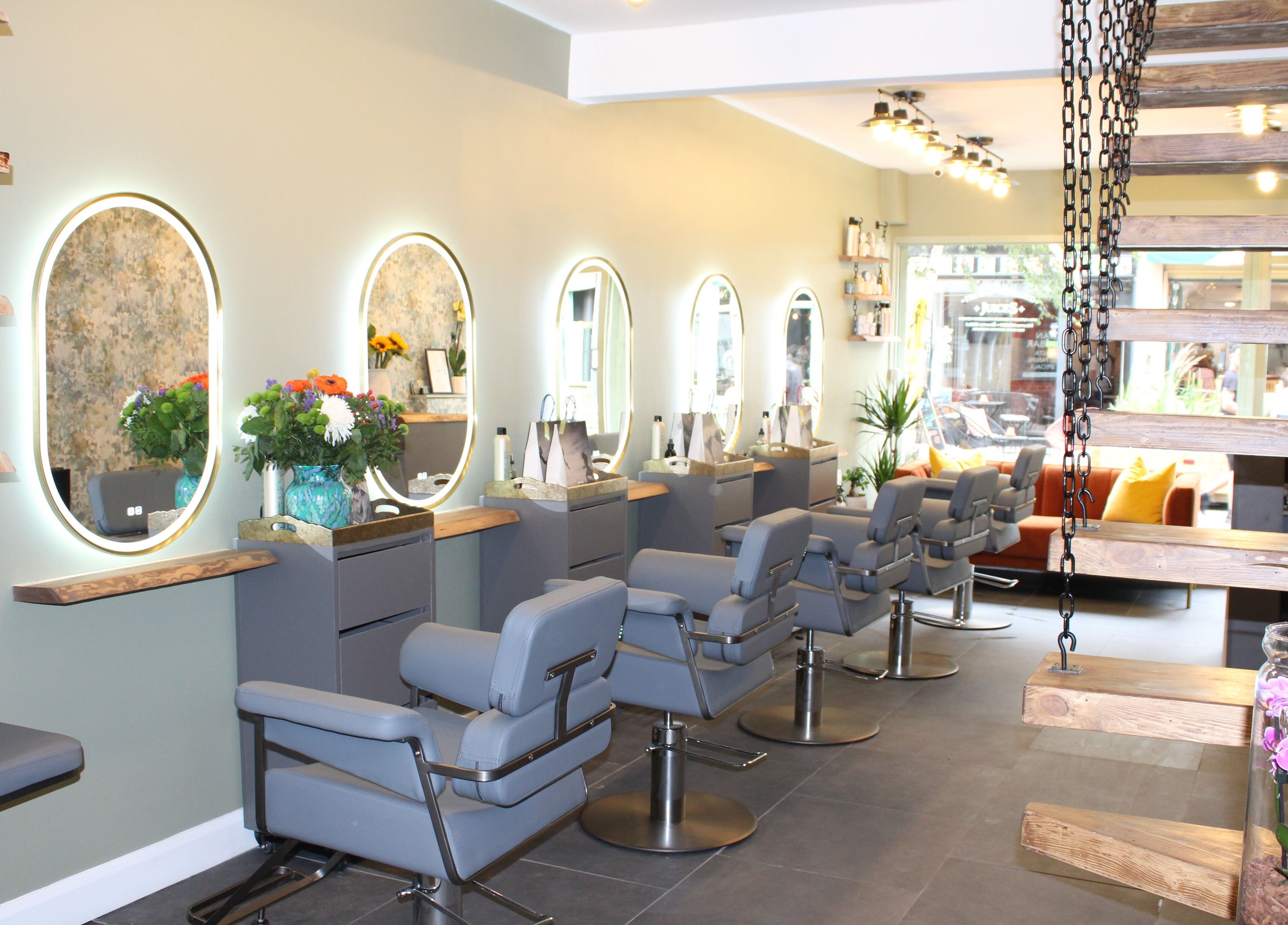 Interior of Hair Spring Studio in London, England, GB with stylish chairs and illuminated mirrors.
