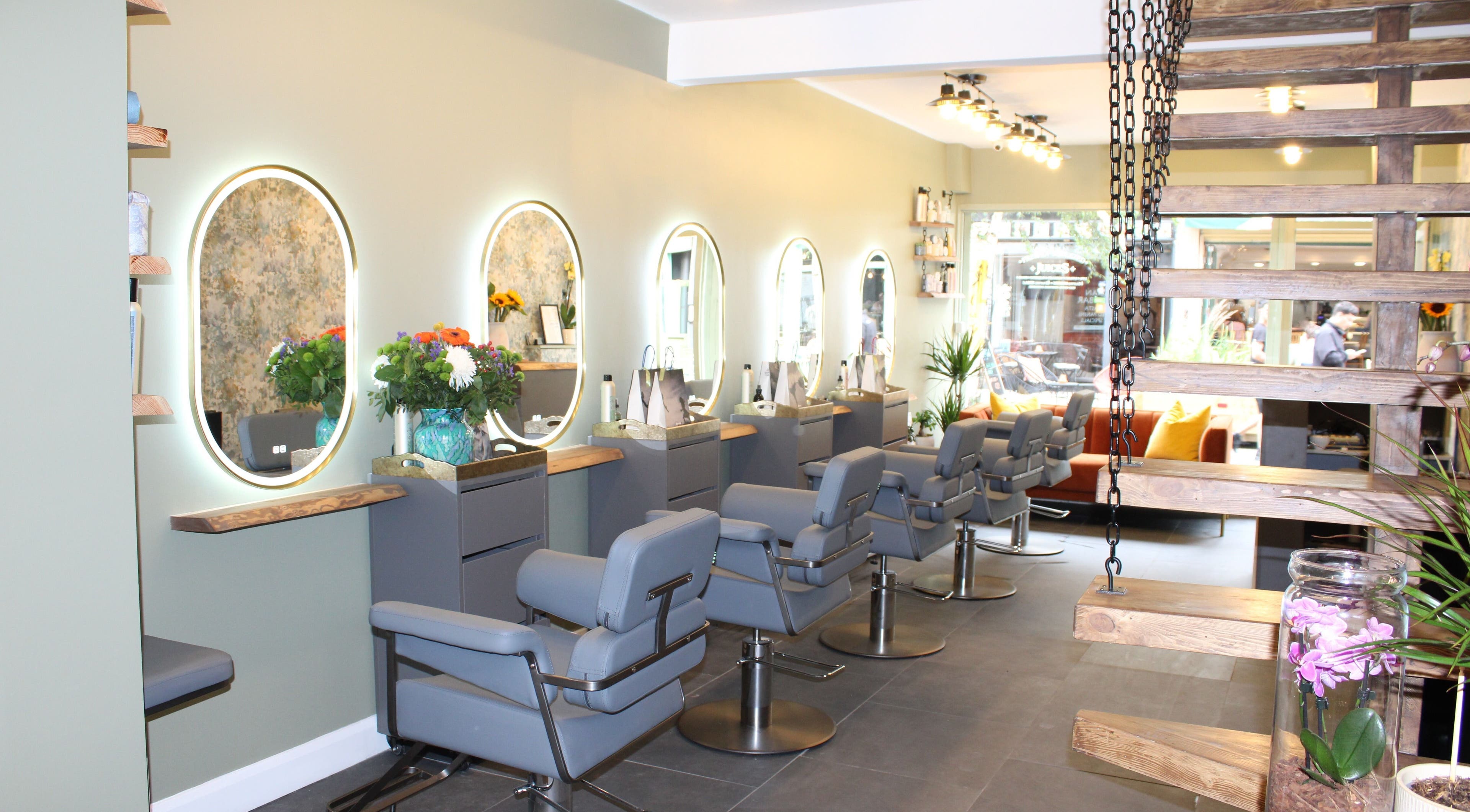 Interior of Hair Spring Studio in London, England, GB with stylish chairs and illuminated mirrors.