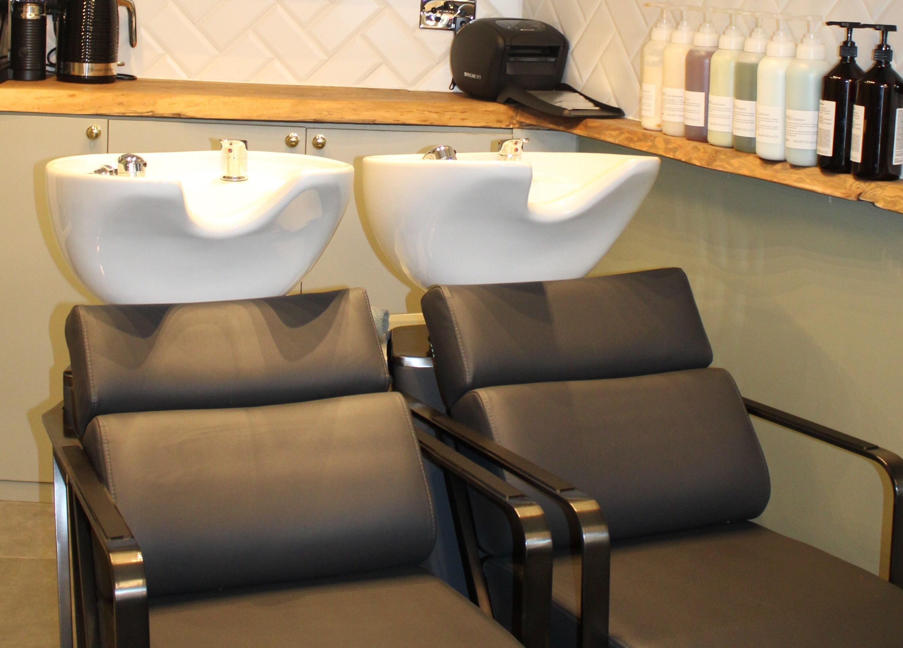Modern shampoo area at Hair Spring Studio, London, England, GB. Stylish basins and products.