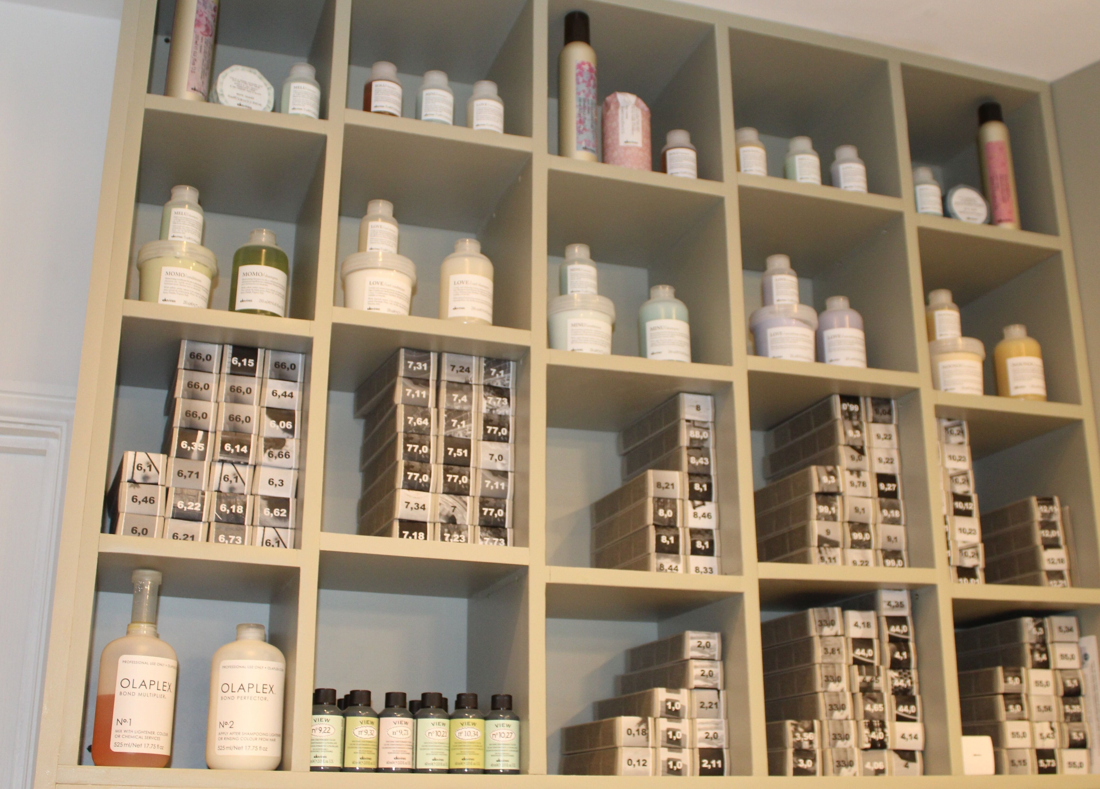 Hair products neatly organized on shelves at Hair Spring Studio, London, England, GB.