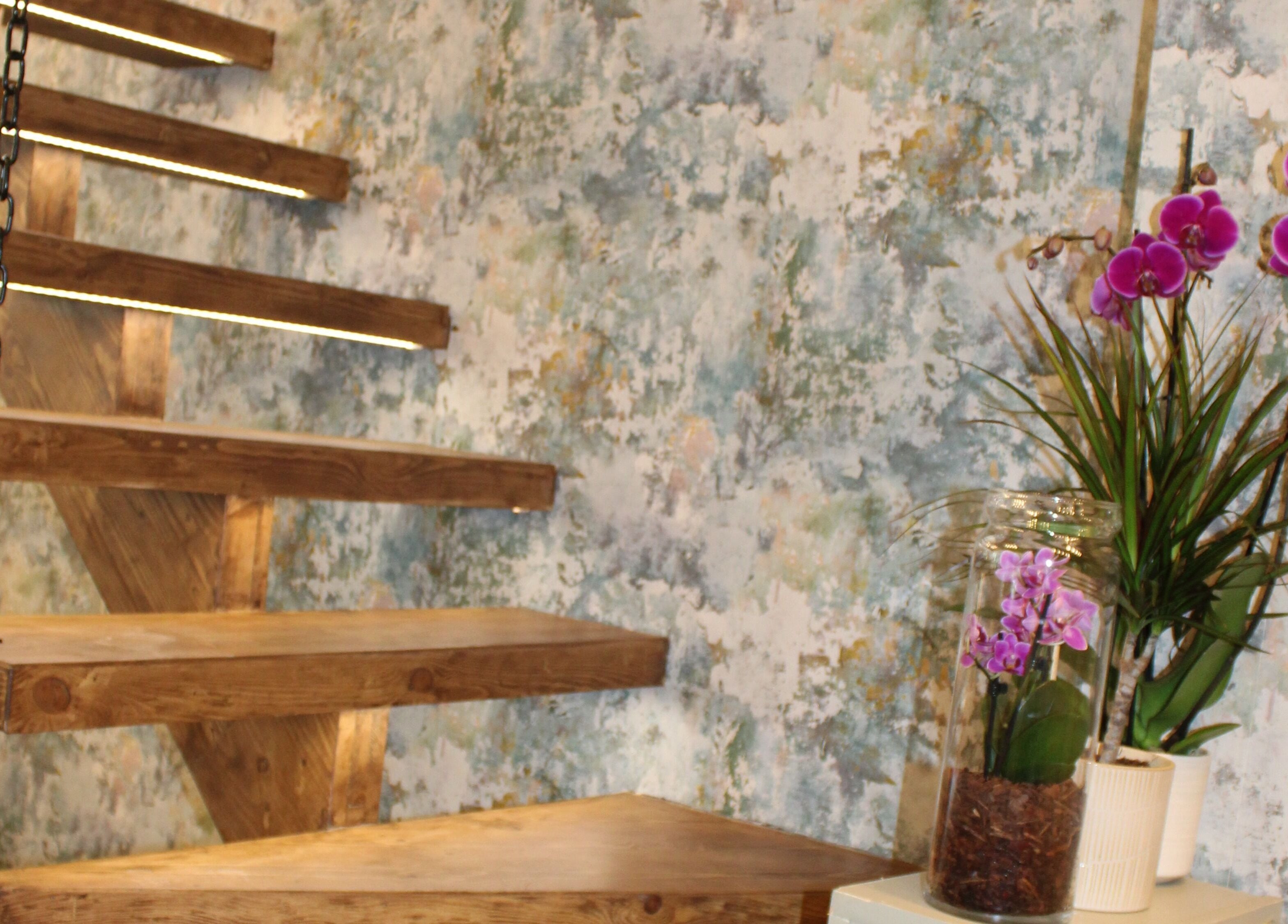 Wooden stairs and orchids enhance the serene ambiance at Hair Spring Studio, London, England, GB.