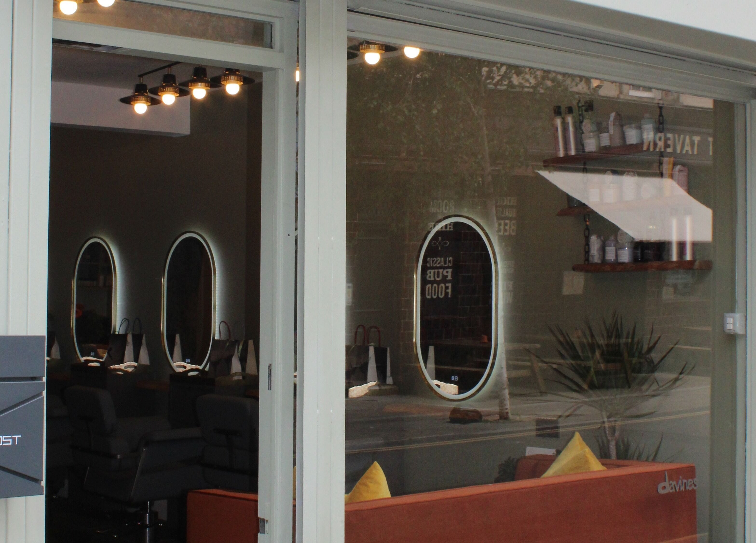 Front view of Hair Spring Studio in London, England, GB with stylish interior reflections in the glass.