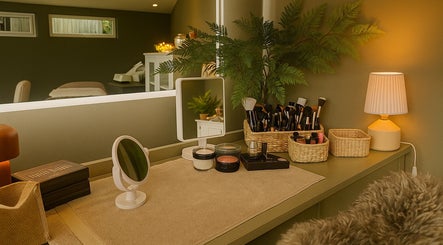 Cozy makeup vanity at Fig Tree Cabin, Box, England, GB with brushes, mirror, and lamp for a soothing ambiance.
