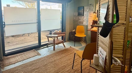 Inviting interior of Natural Edge Beulah Therapy, Devonport, Tasmania, AU with bright decor and seating.