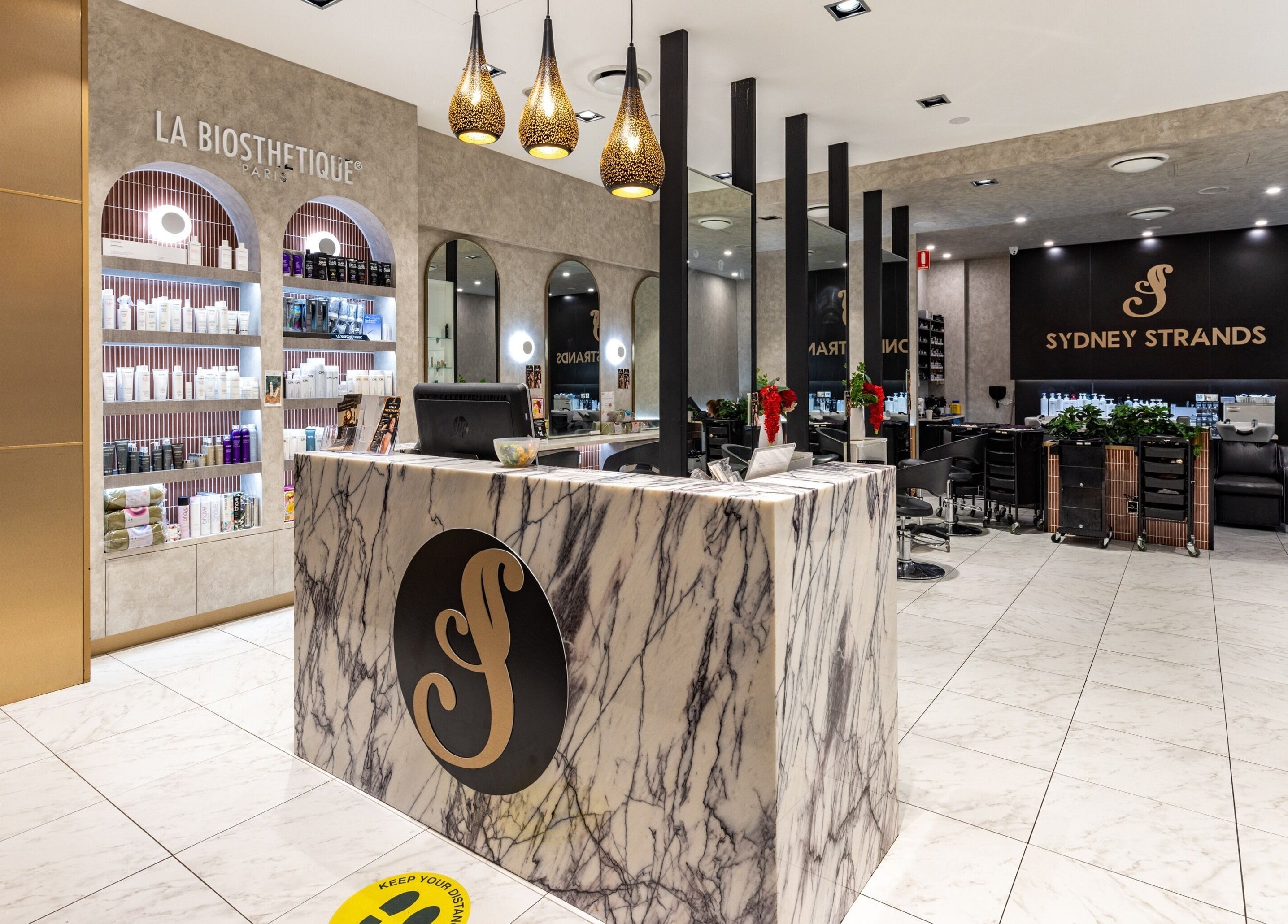 Elegant interior of Sydney Strands on Kingsway, Miranda NSW, AU featuring marble reception and product displays.