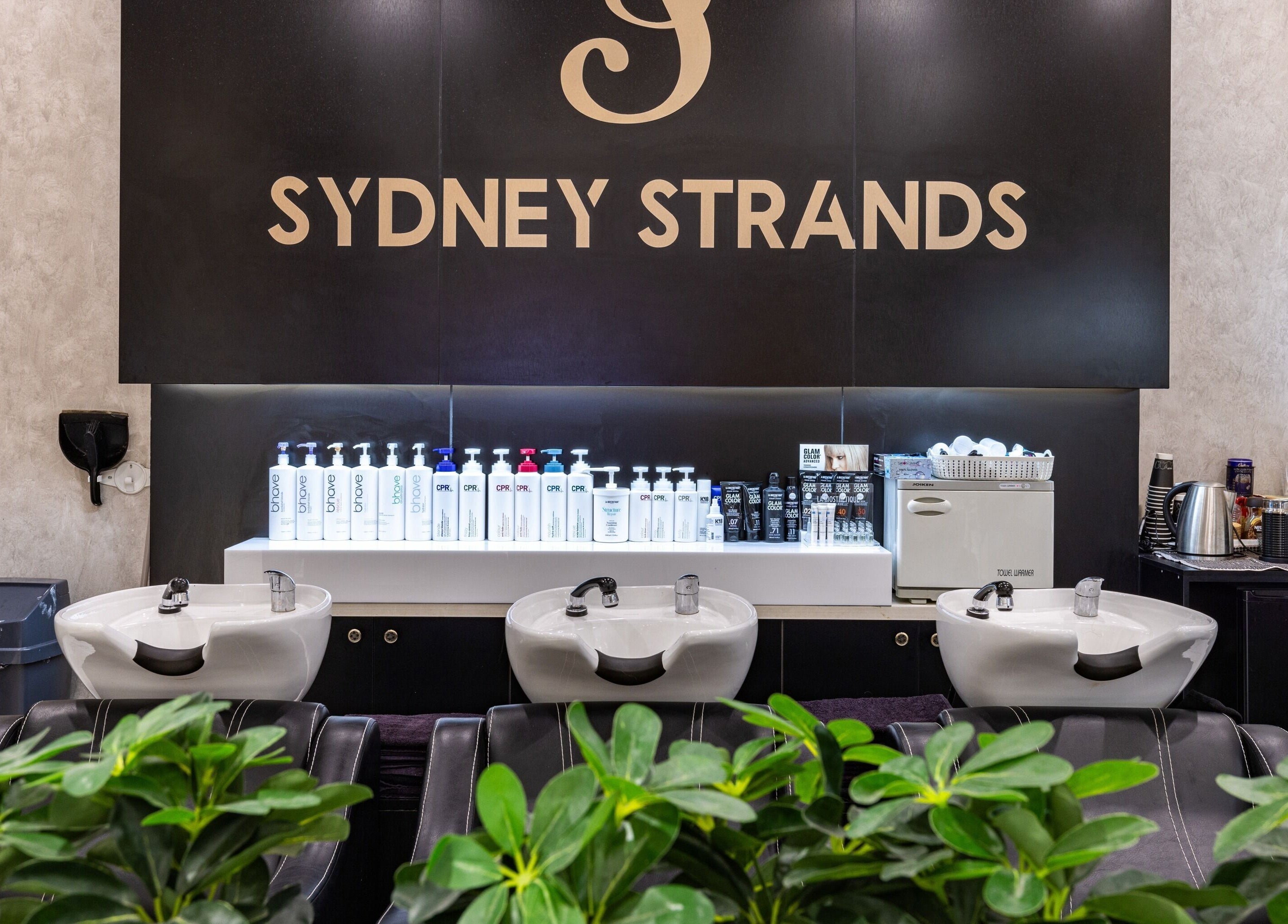 Modern hair washing station at Sydney Strands, Kingsway, Miranda NSW, AU with branded products displayed.