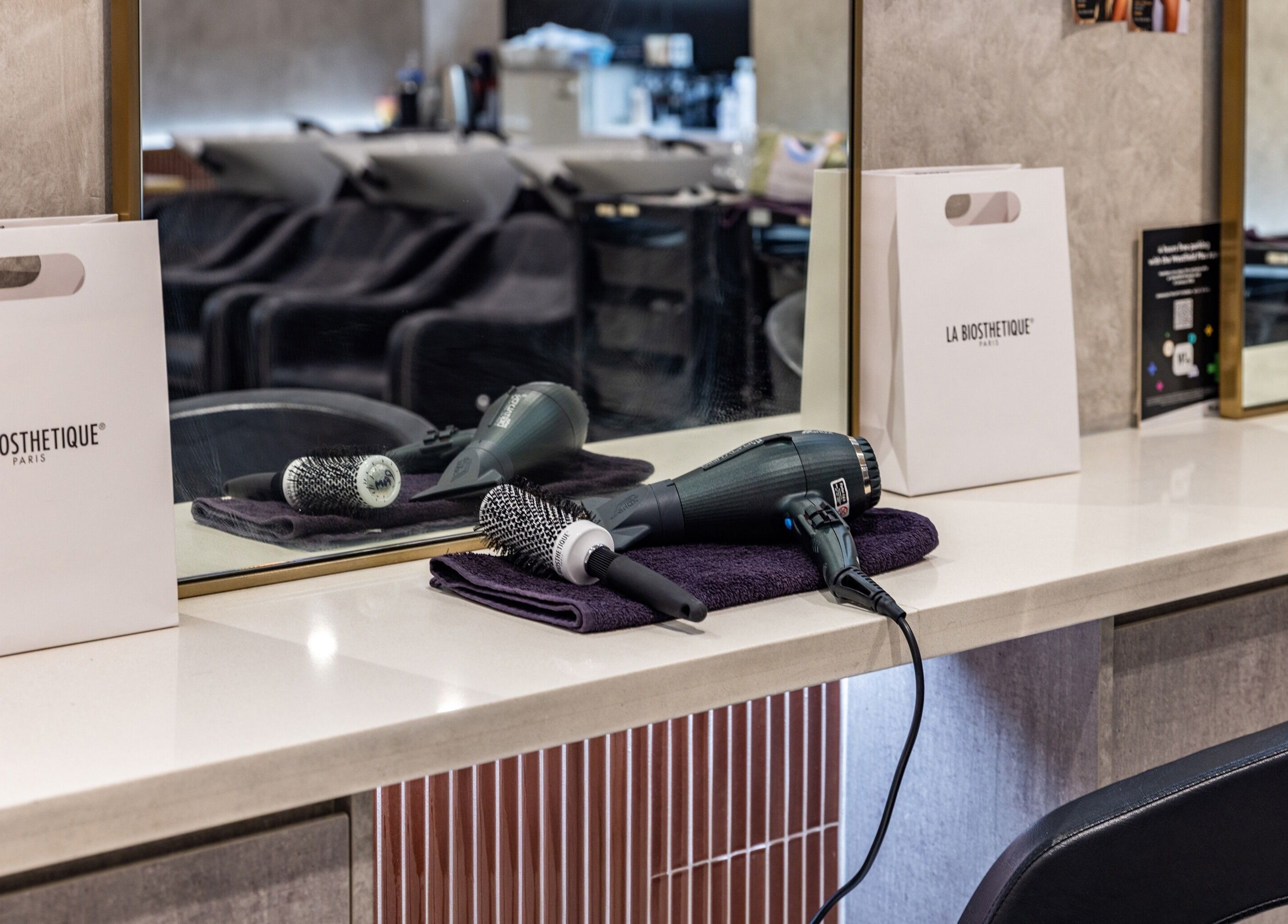 Sydney Strands salon interior with hair tools on Kingsway, Miranda NSW, AU, showcasing elegant styling area.