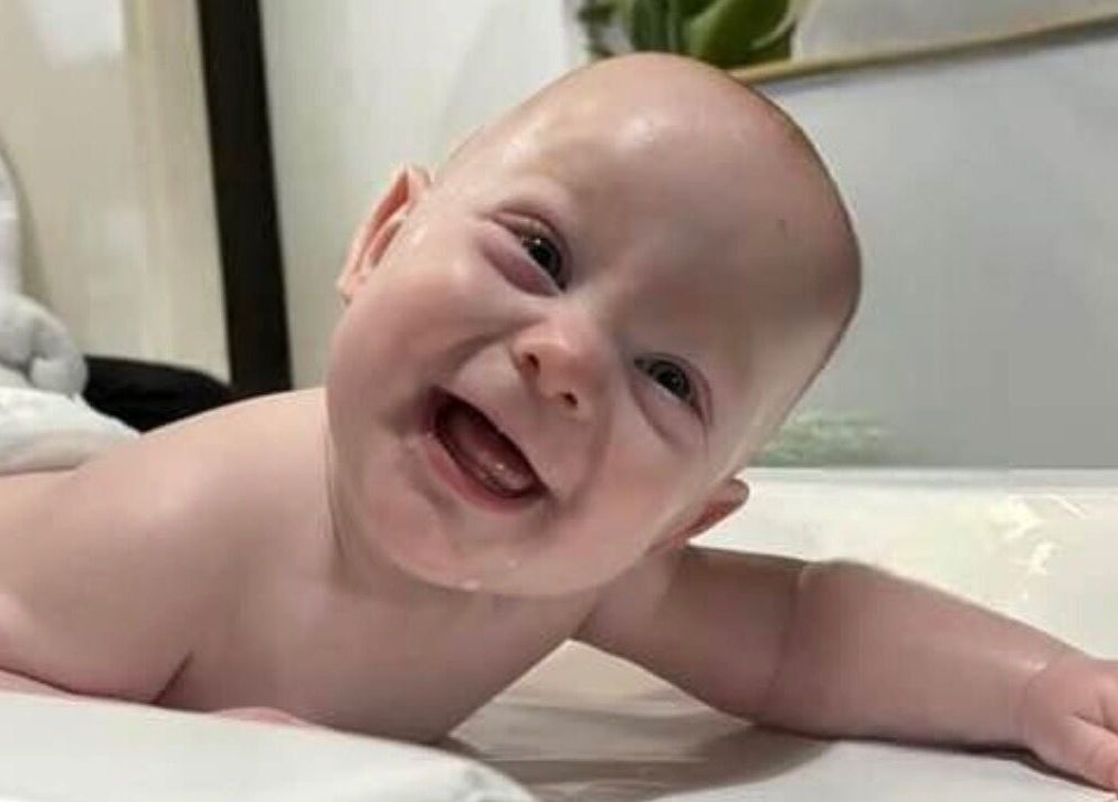Smiling baby during a massage session at Daydreams Infant Massage, Dianella, Western Australia, AU.