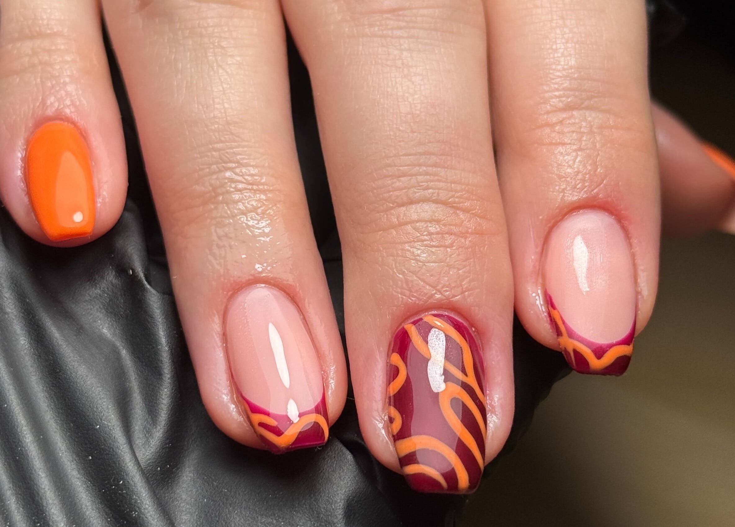 Stylish orange and red nail art at A Touch of Beauty by Jasmine Charlotte, Hereford, England, GB.