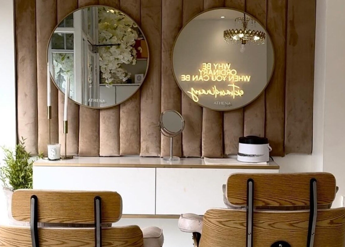 Elegant beauty room at Athena Mortlake, London, England, GB with stylish mirrors and chic decor.