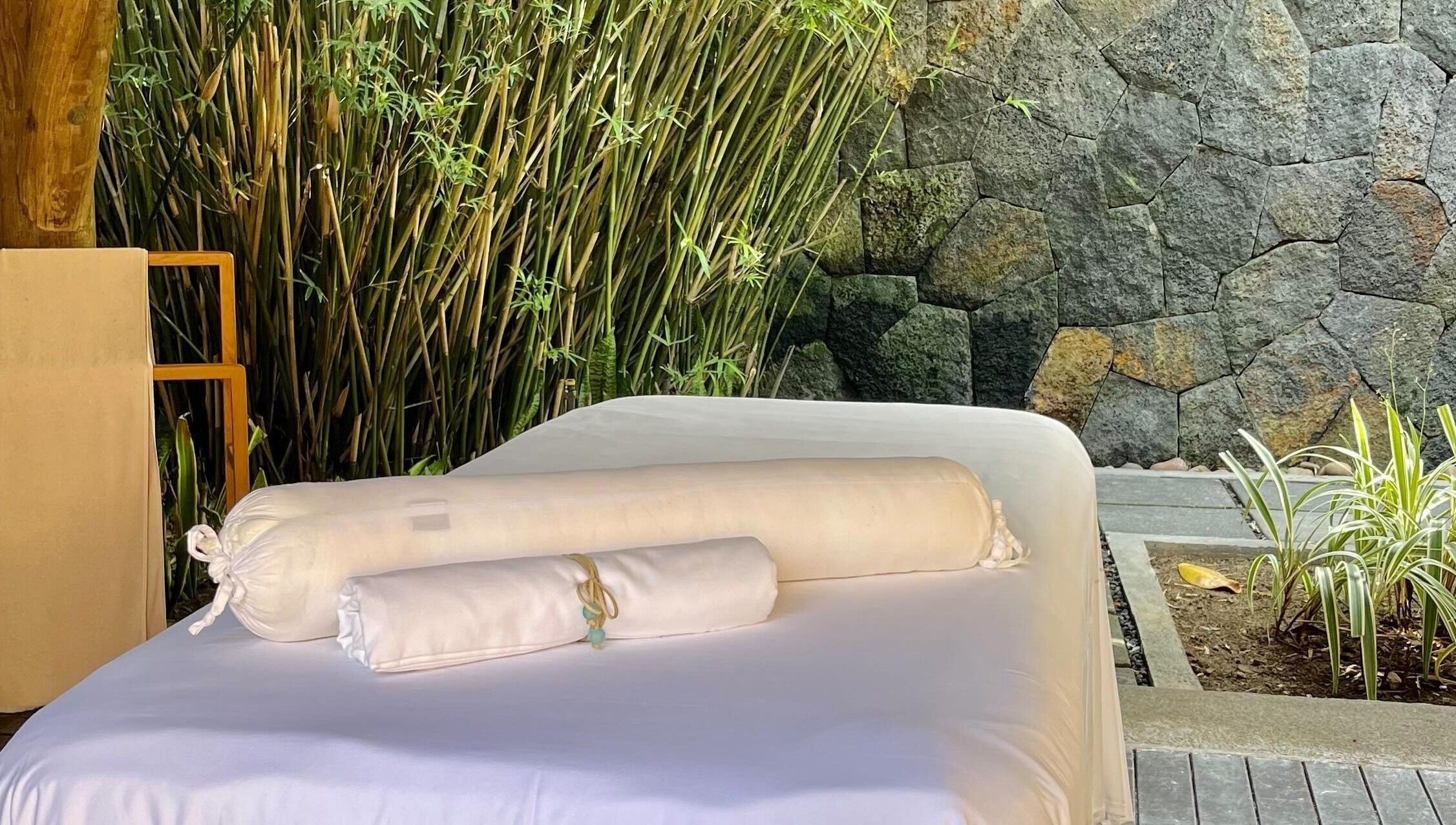 Outdoor spa table surrounded by bamboo at Living Well with Milly, Hereford, England, GB.