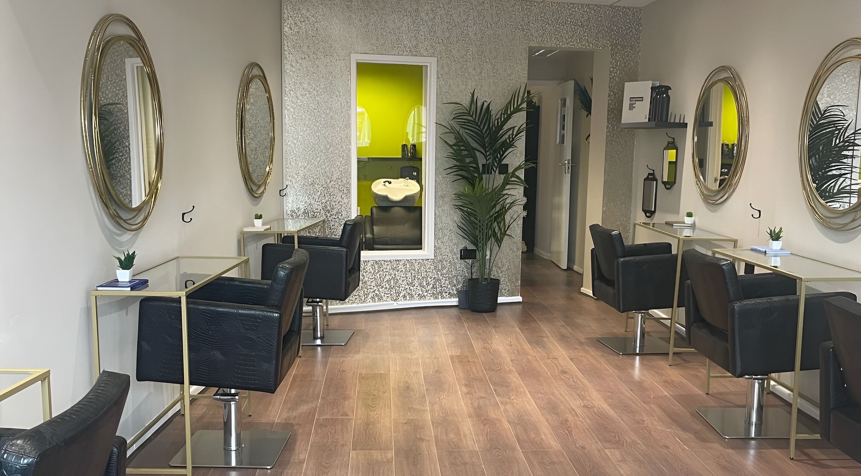 Chic interior of Sassi Hair salon in Warrington, England, GB with mirrors and chairs.