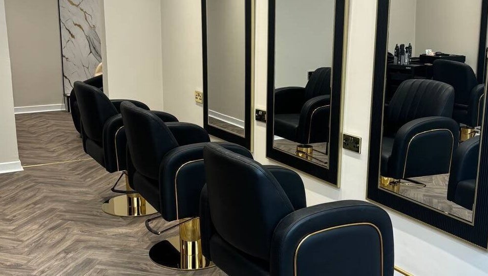 Modern salon chairs with mirrors at MUSE, Greenock, Scotland, GB, offering a stylish beauty experience.