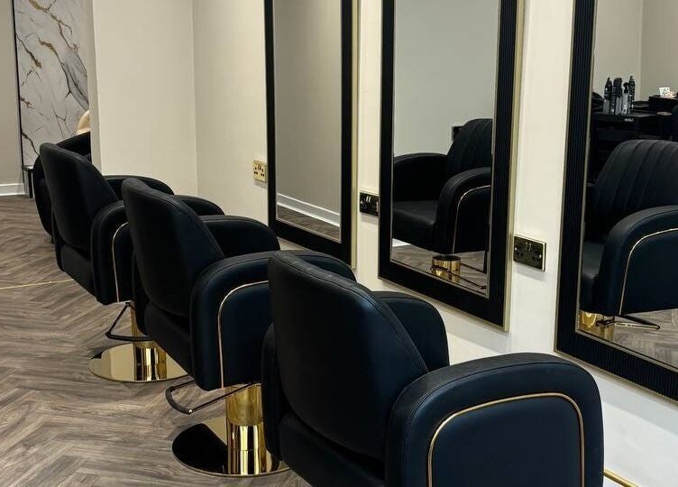 Sleek salon chairs and mirrors in MUSE, Greenock, Scotland, GB offering modern beauty services.
