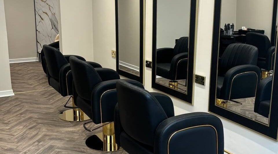 Sleek salon chairs and mirrors in MUSE, Greenock, Scotland, GB offering modern beauty services.