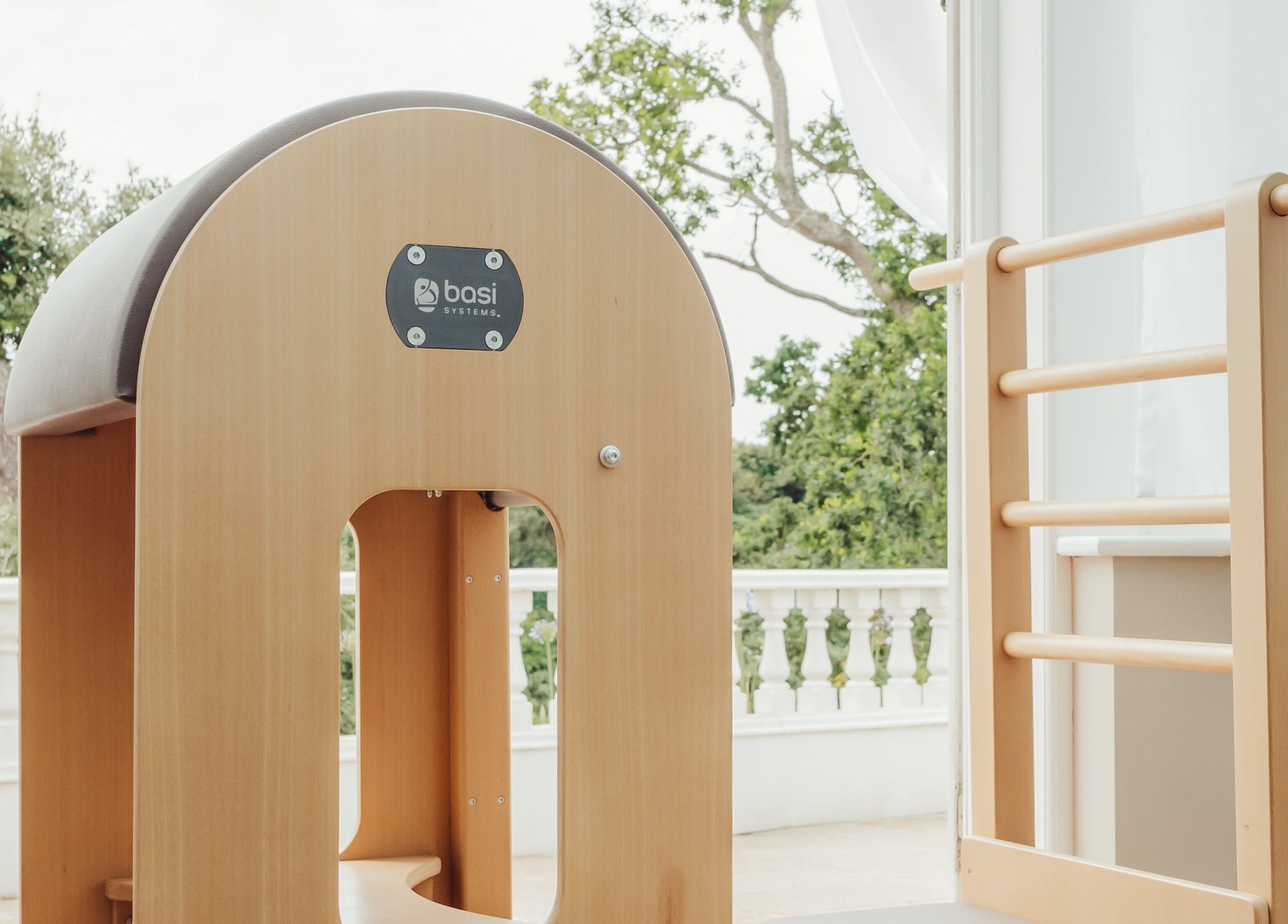 Pilates equipment at Reform Pilates ~ Rebecca Middleton, St. Ouen, Jersey, JE, showcasing serene outdoor setting.