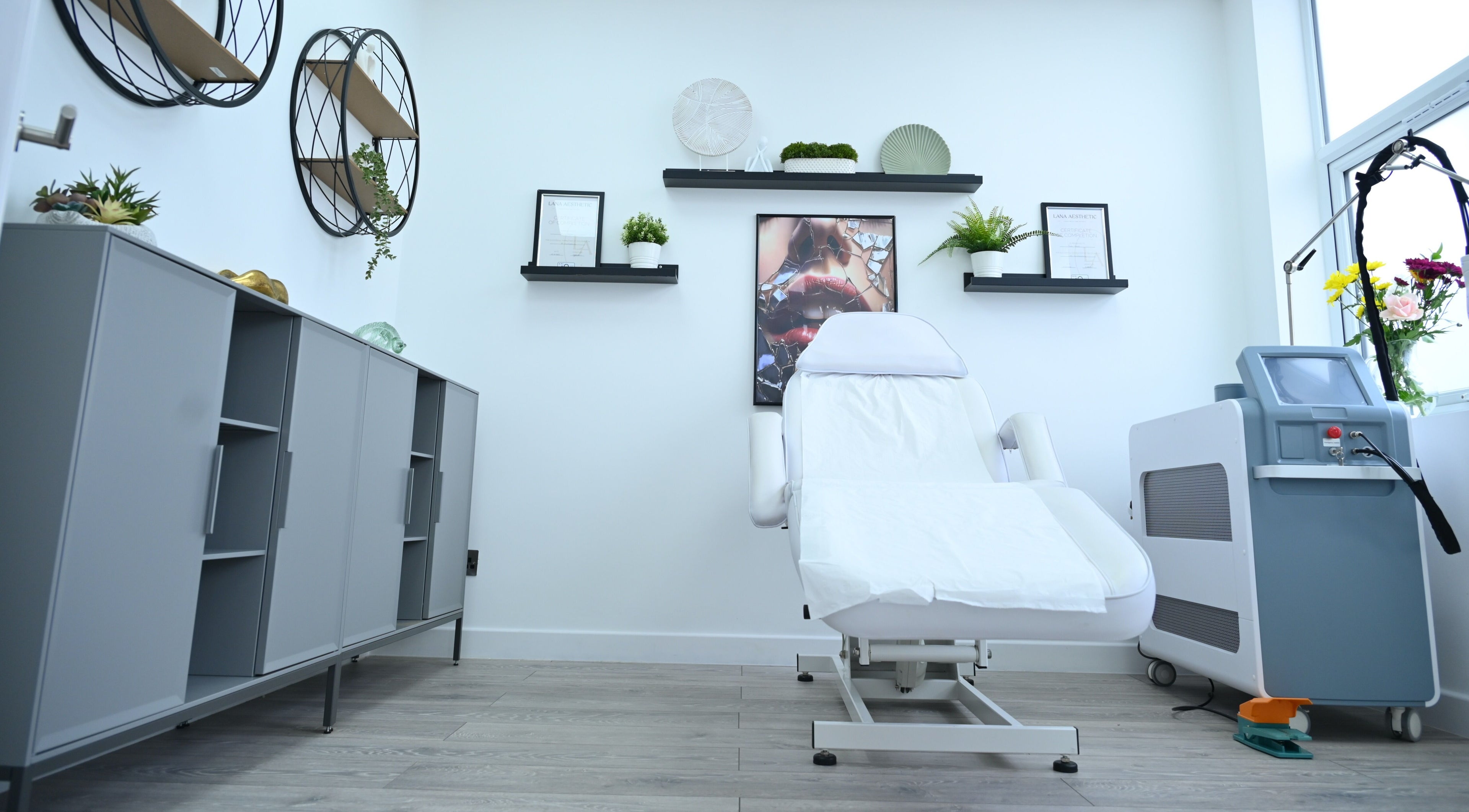 Modern treatment room at Mraya Clinic, Northwood, England, GB featuring a sleek chair and equipment.