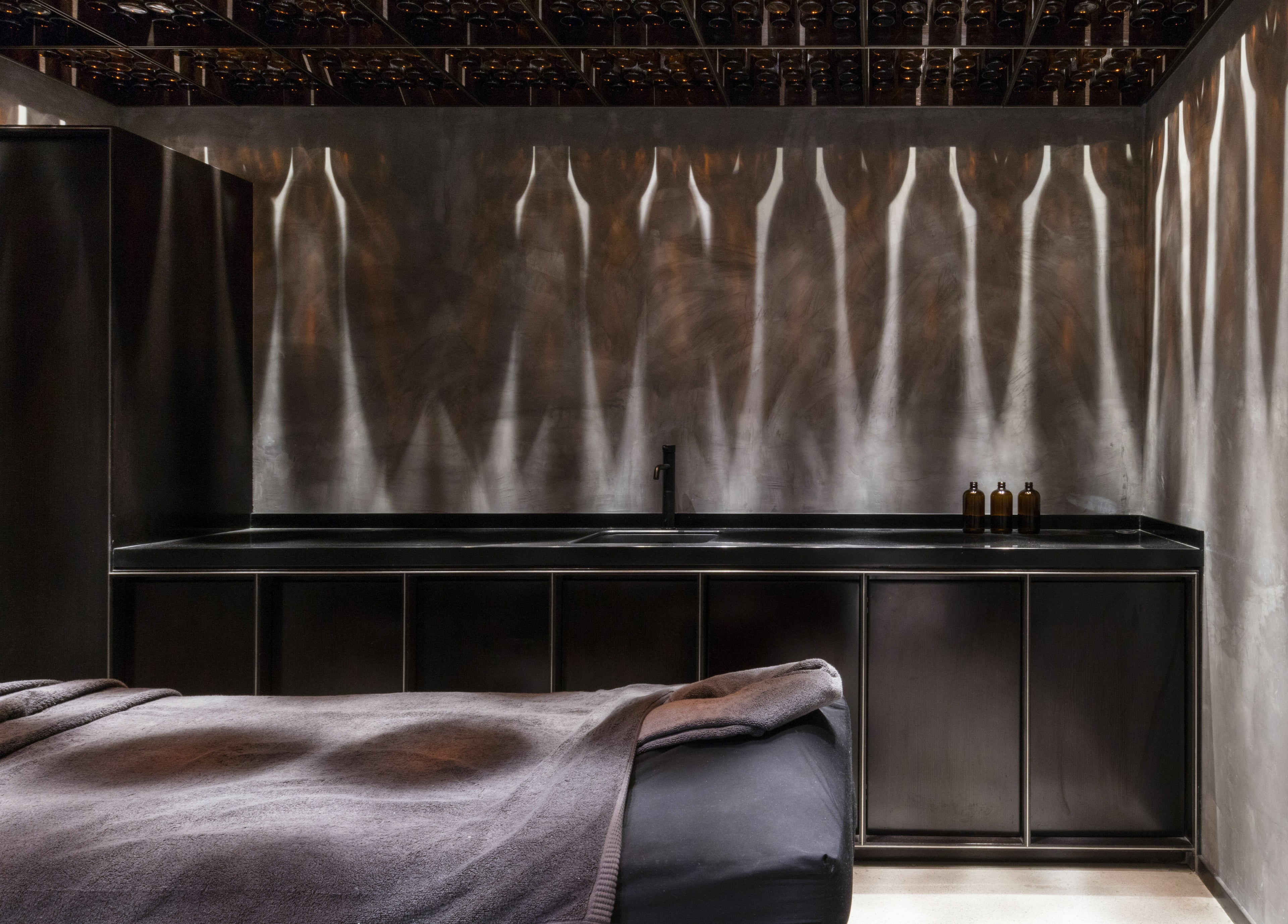 Luxurious spa room at Chaps & Co Dubai Design District D3, Dubai, AE with elegant decor and ambient lighting.