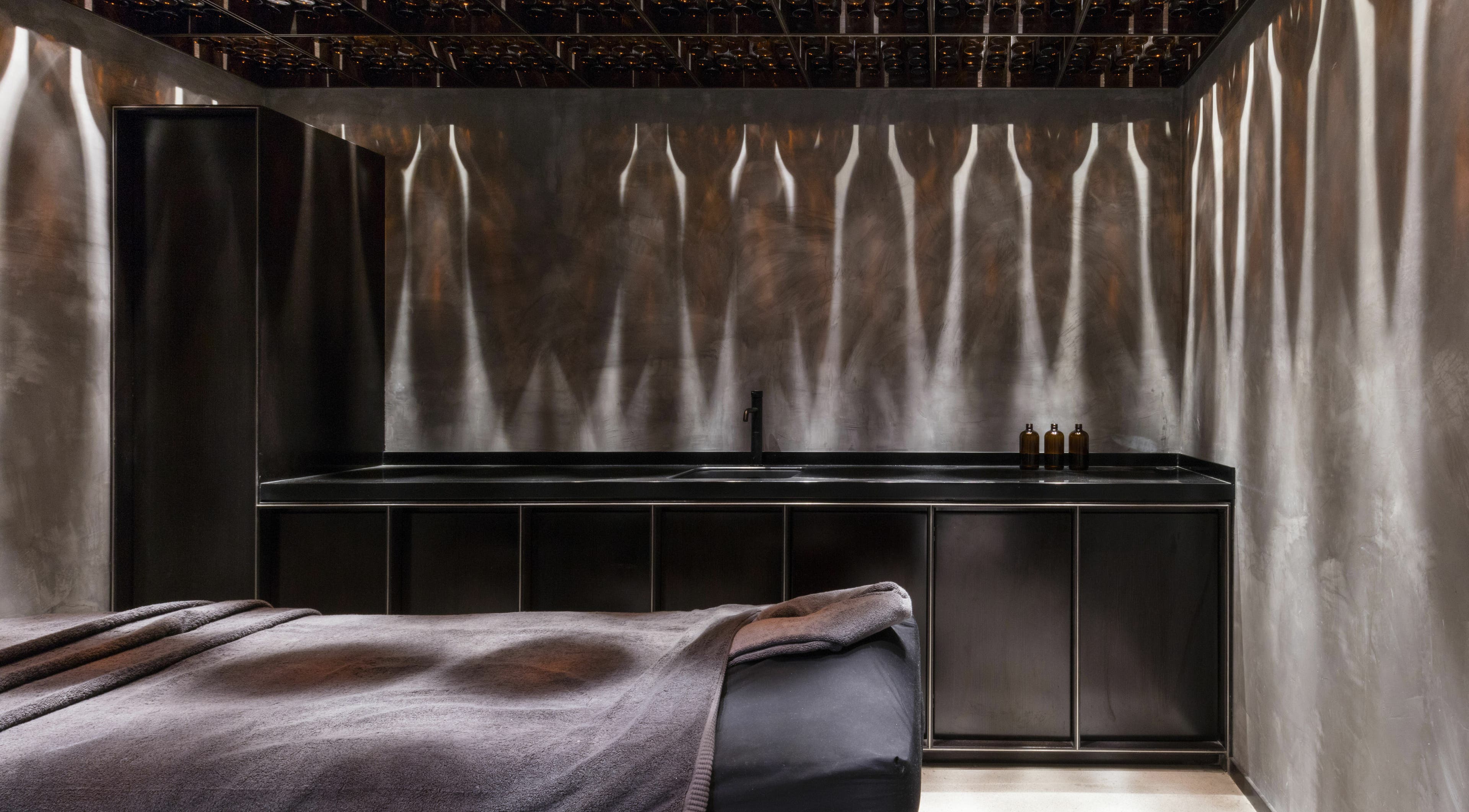 Luxurious spa room at Chaps & Co Dubai Design District D3, Dubai, AE with elegant decor and ambient lighting.