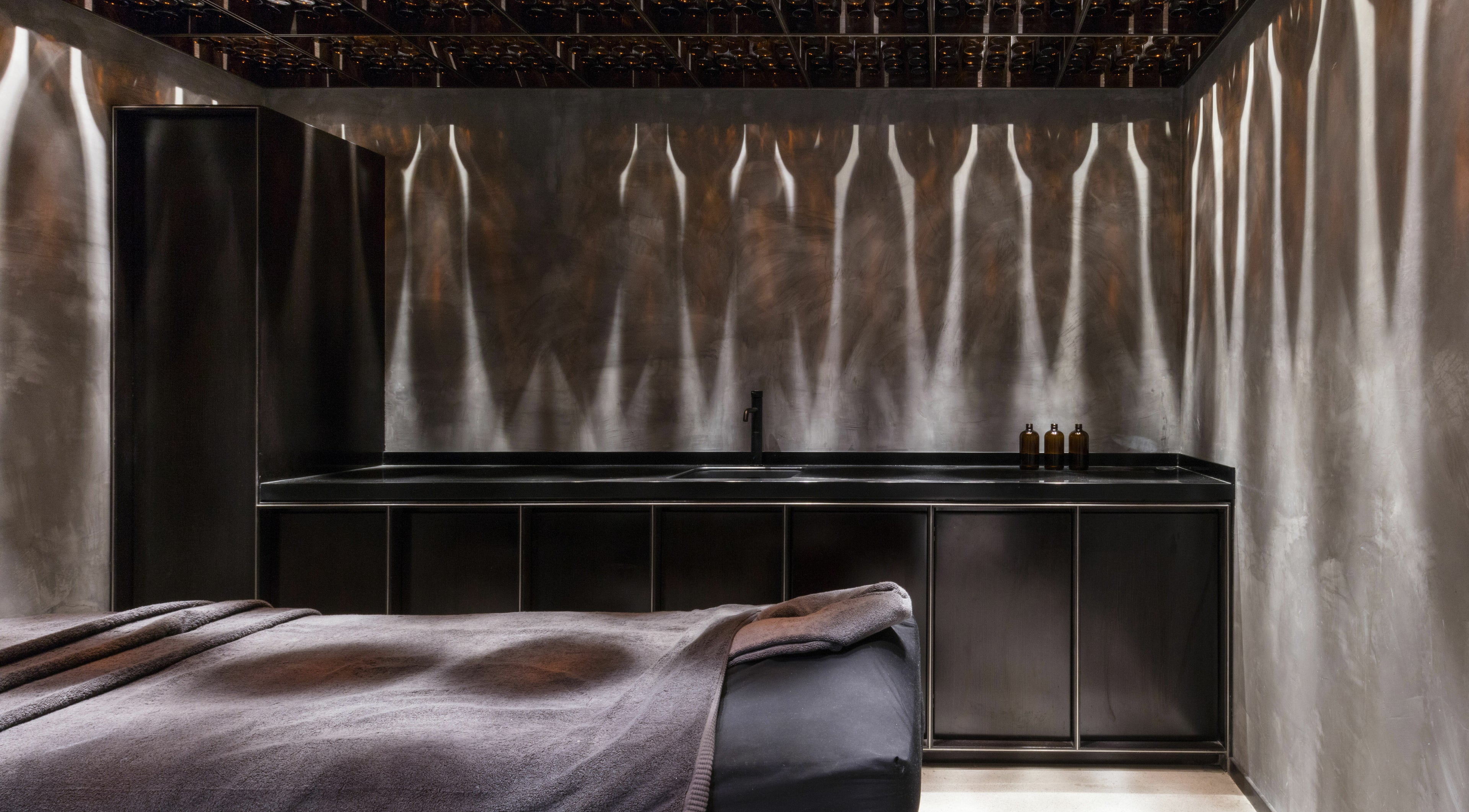 Luxurious spa room at Chaps & Co Dubai Design District D3, Dubai, AE with elegant decor and ambient lighting.