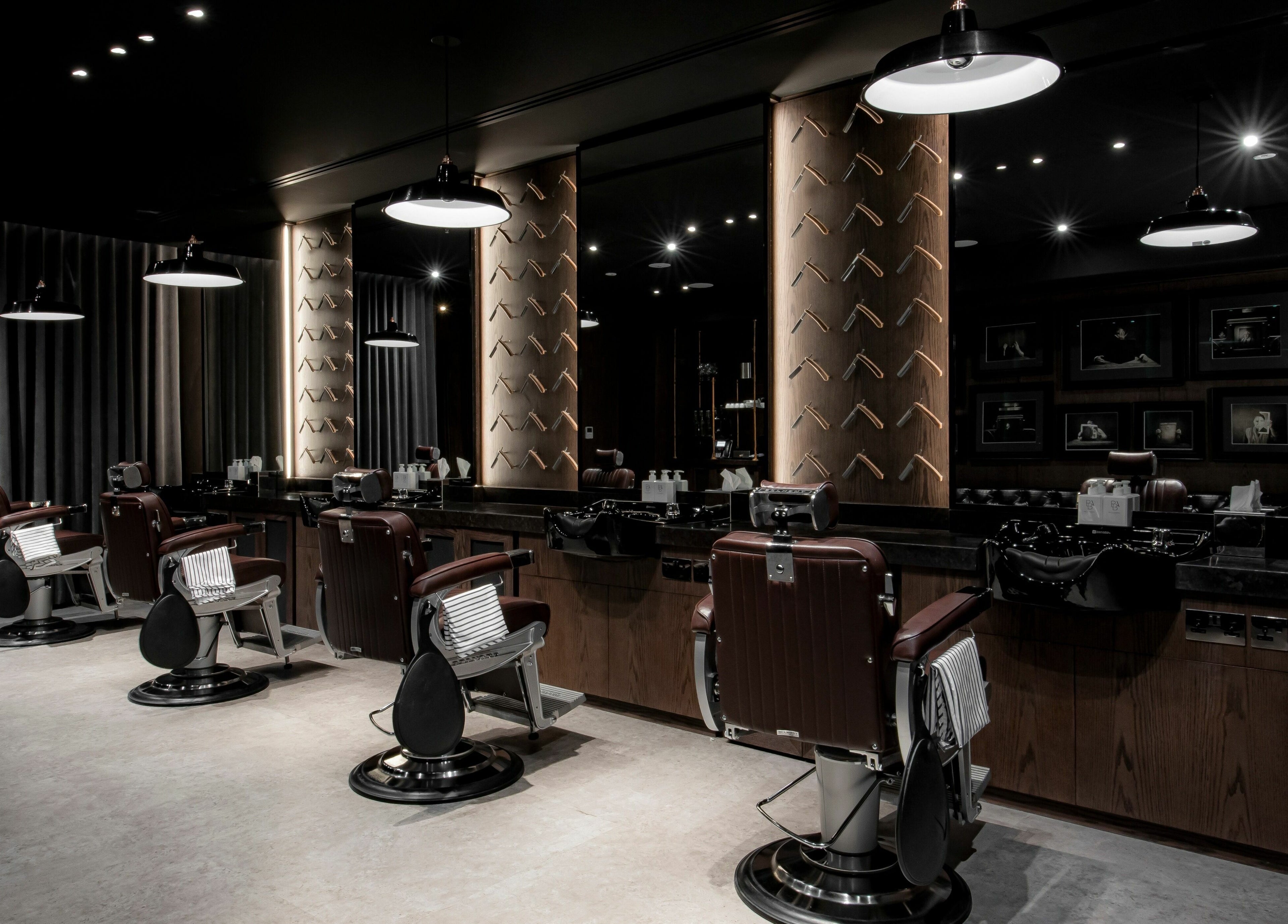 Elegant interior of Chaps & Co Edition Hotel Al Bateen Marina, Abu Dhabi, featuring premium barber chairs and decor.