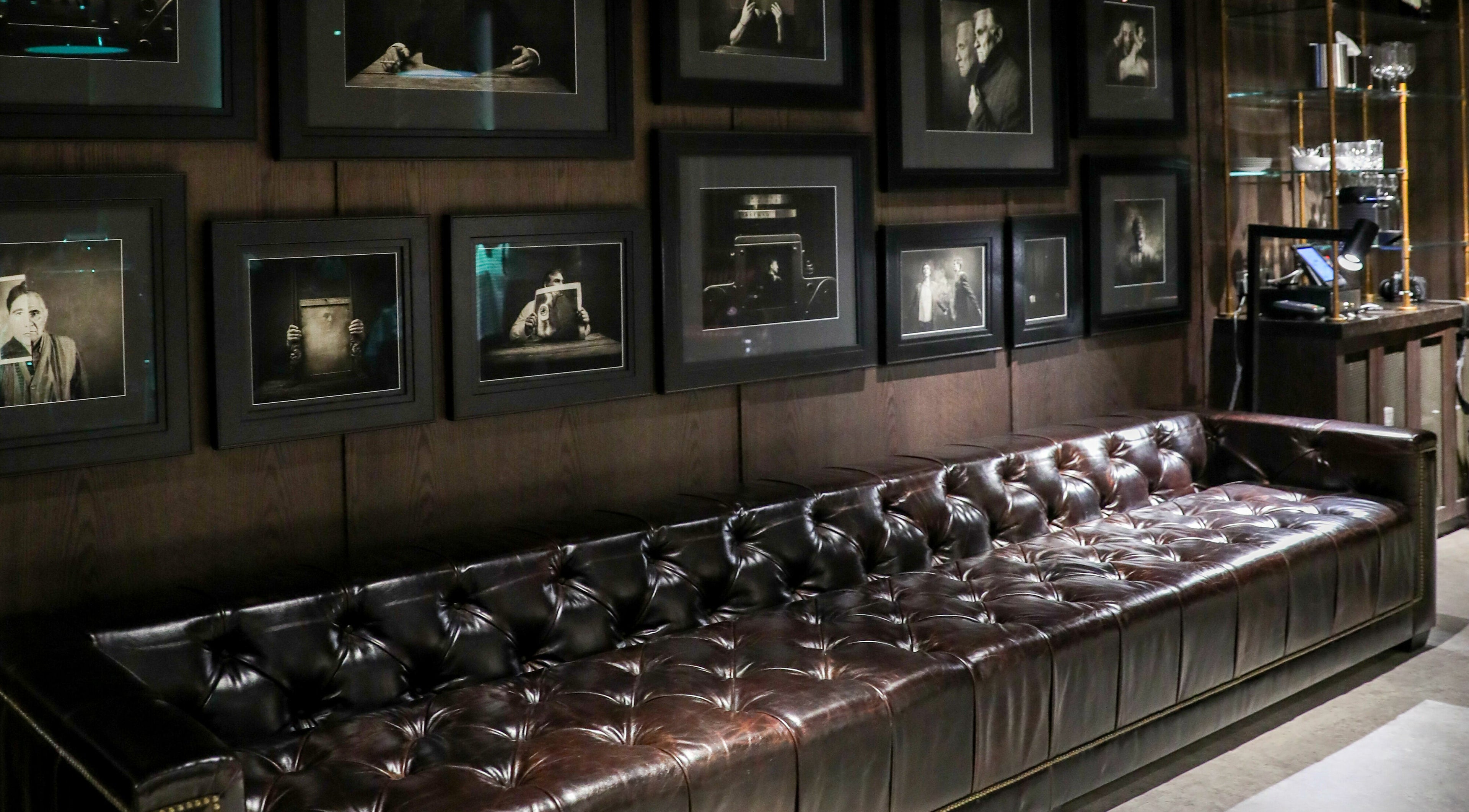 Chic leather sofa with vintage photos at Chaps & Co Edition Hotel Al Bateen Marina, Abu Dhabi, Abu Dhabi, AE.