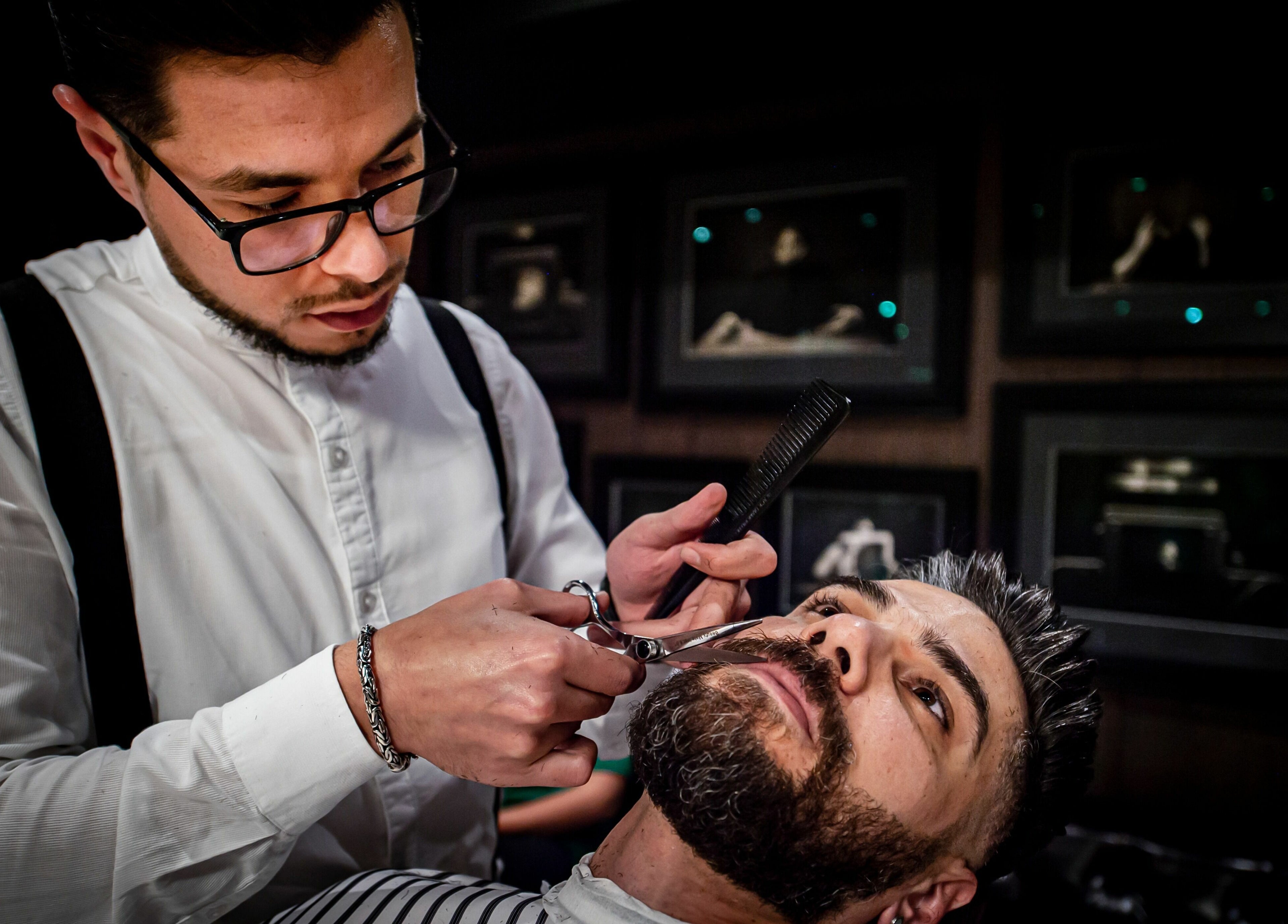 Barber trimming beard at Chaps & Co Edition Hotel Al Bateen Marina, Abu Dhabi, AE.