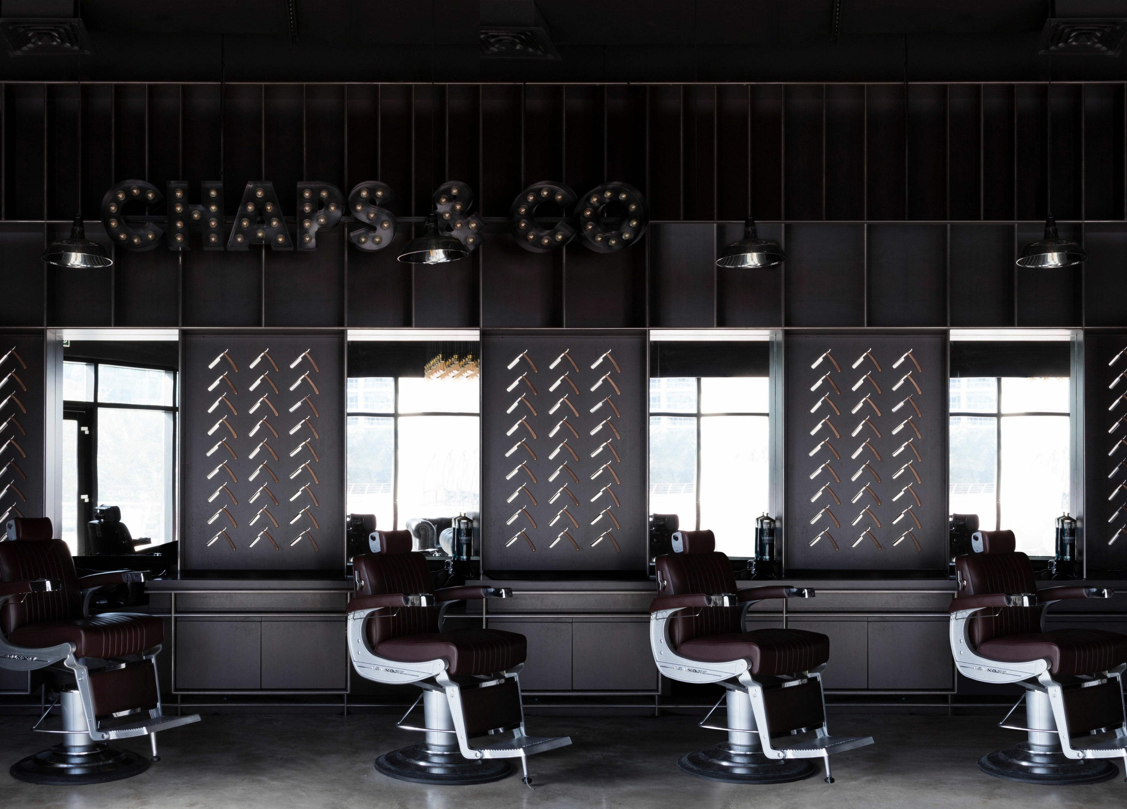 Interior of Chaps & Co - JLT barber shop in Dubai, AE with sleek chairs and modern decor.