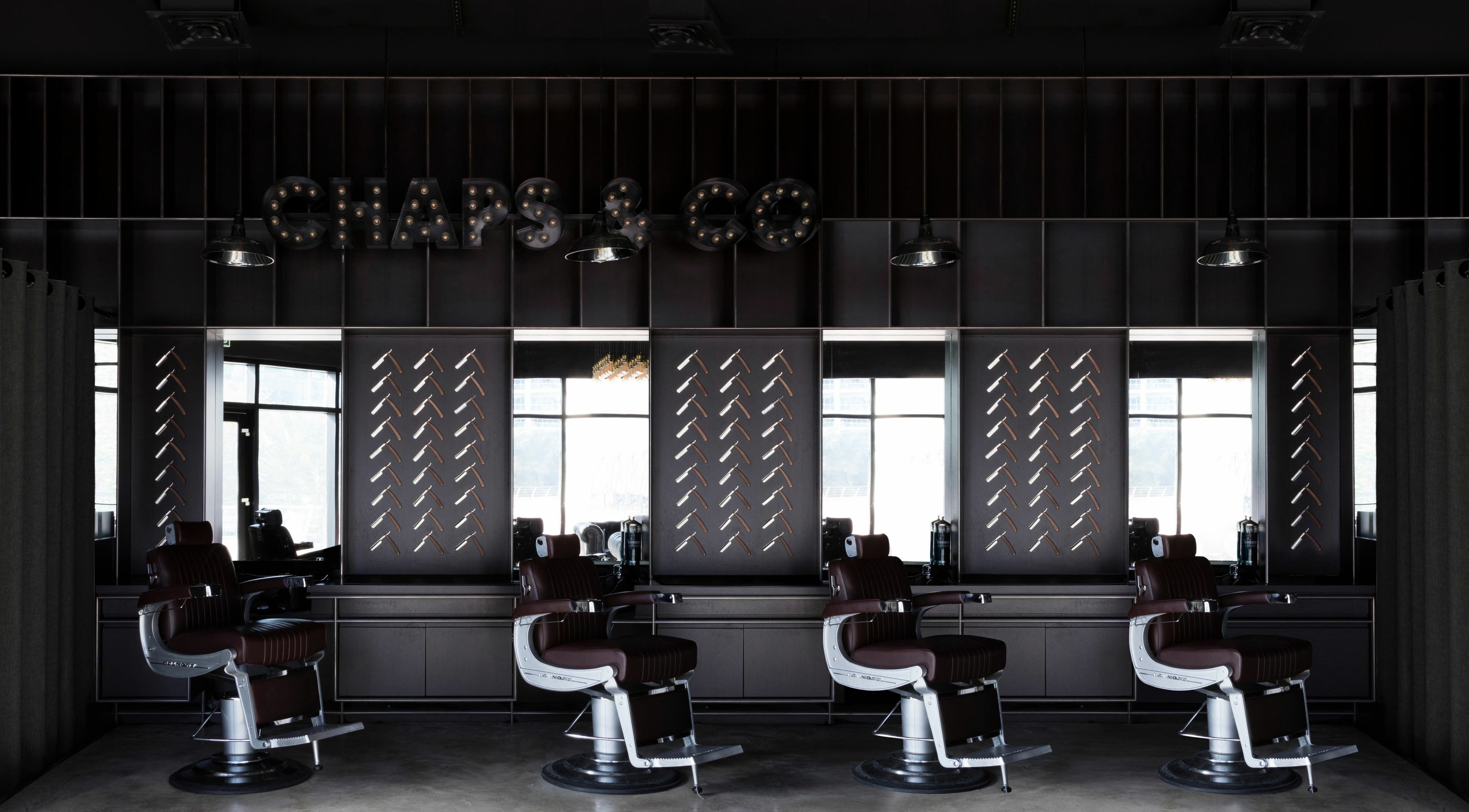 Interior of Chaps & Co - JLT barber shop in Dubai, AE with sleek chairs and modern decor.