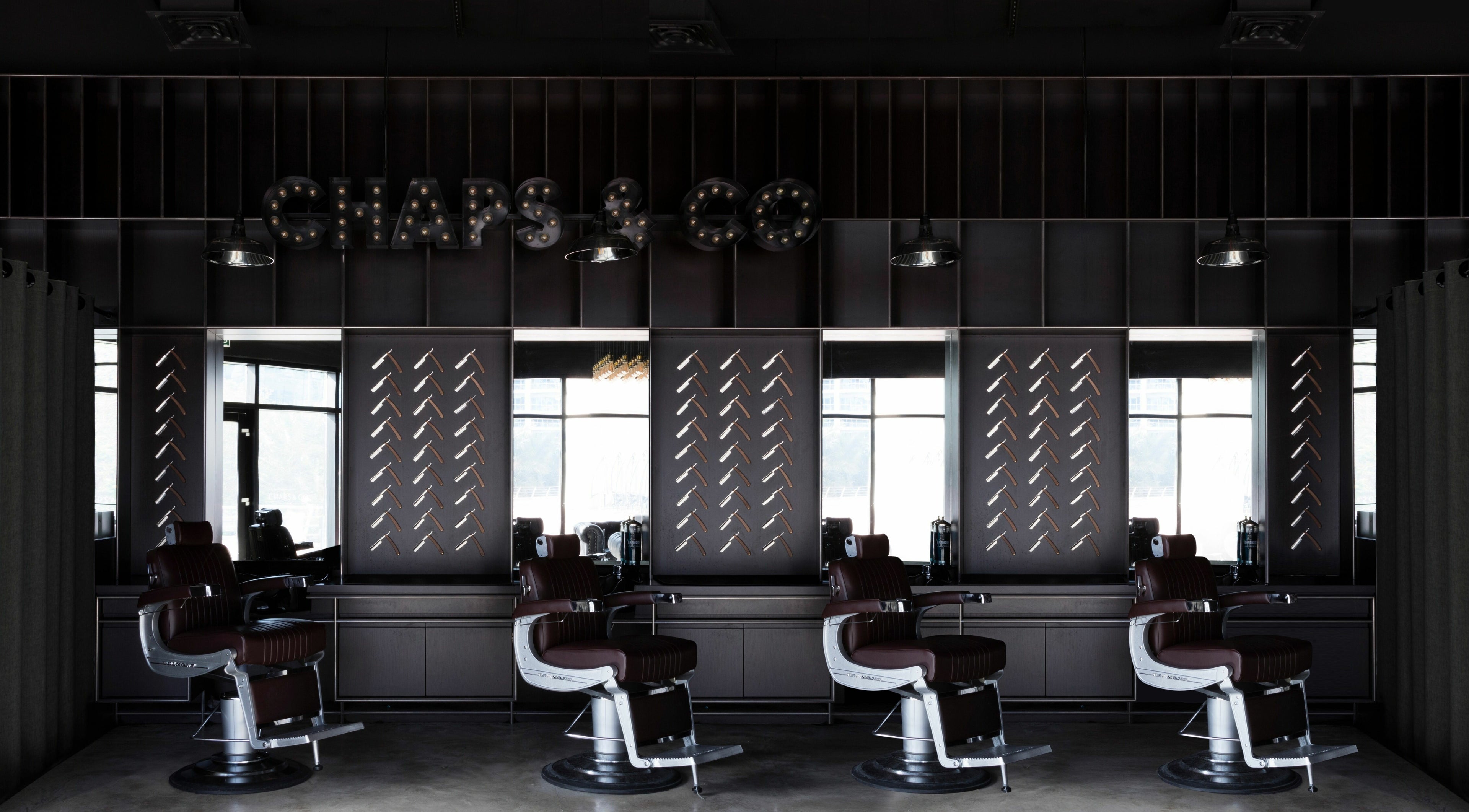 Interior of Chaps & Co - JLT barber shop in Dubai, AE with sleek chairs and modern decor.