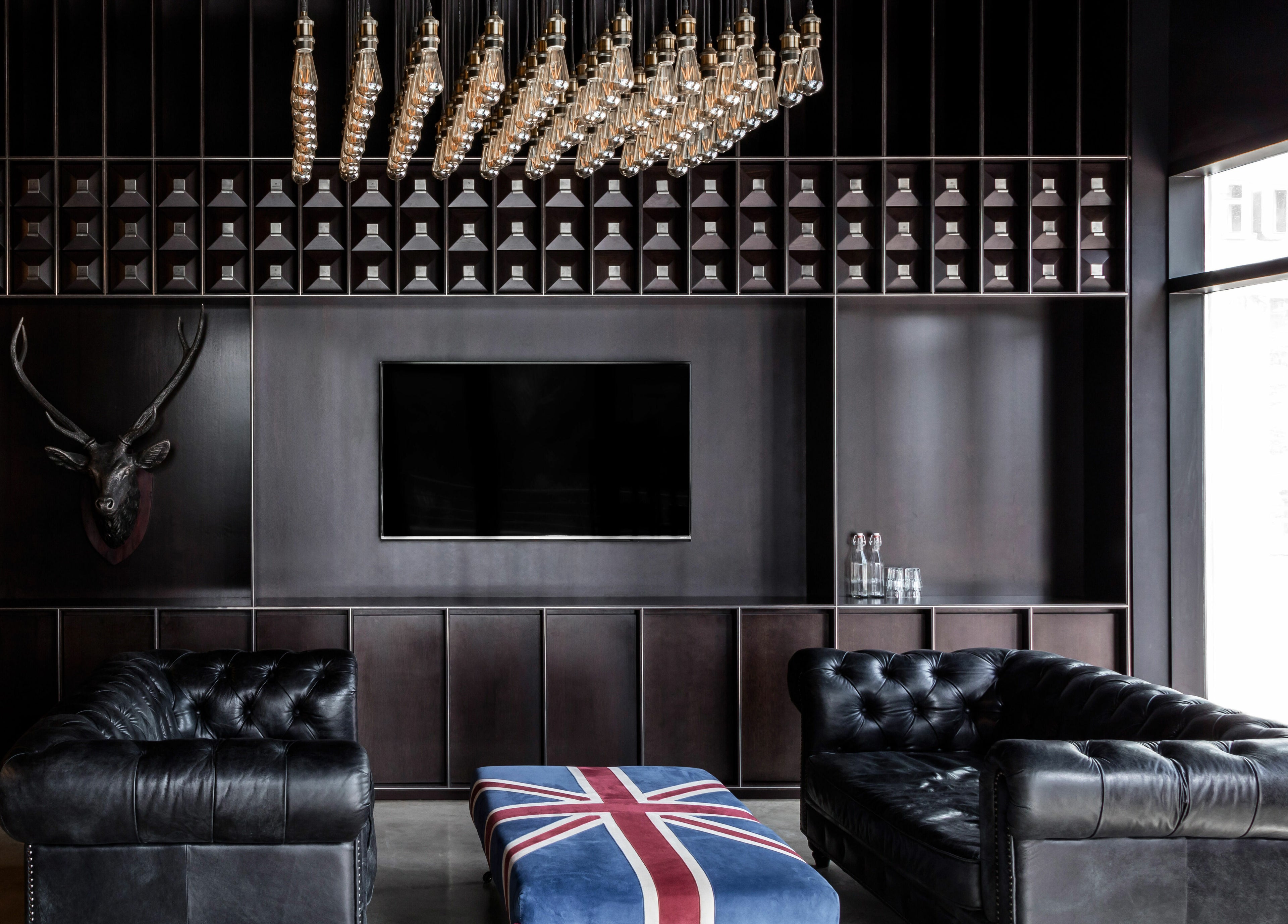 Sophisticated lounge area at Chaps & Co - JLT in Dubai, AE, featuring a stylish decor with leather sofas.