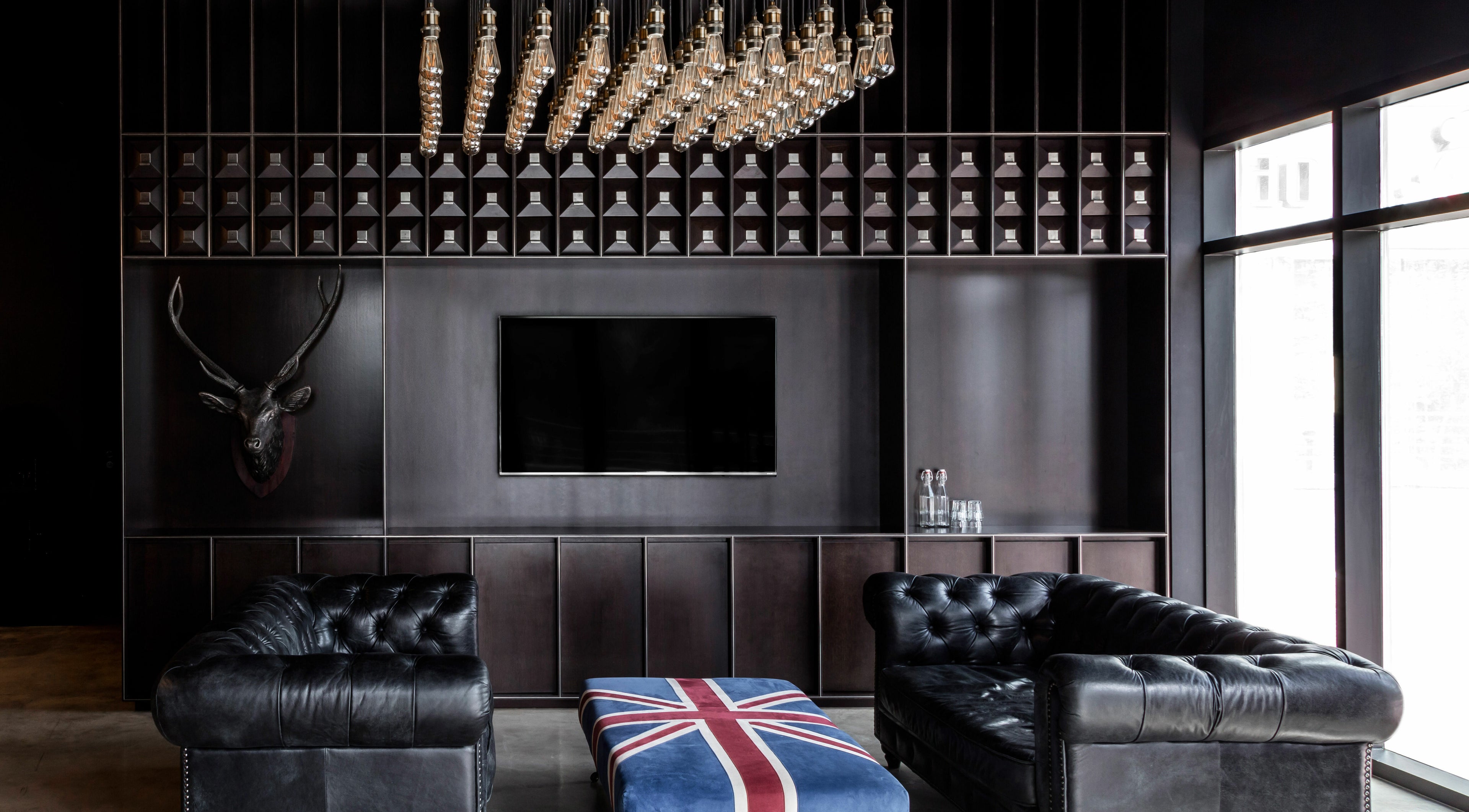 Sophisticated lounge area at Chaps & Co - JLT in Dubai, AE, featuring a stylish decor with leather sofas.