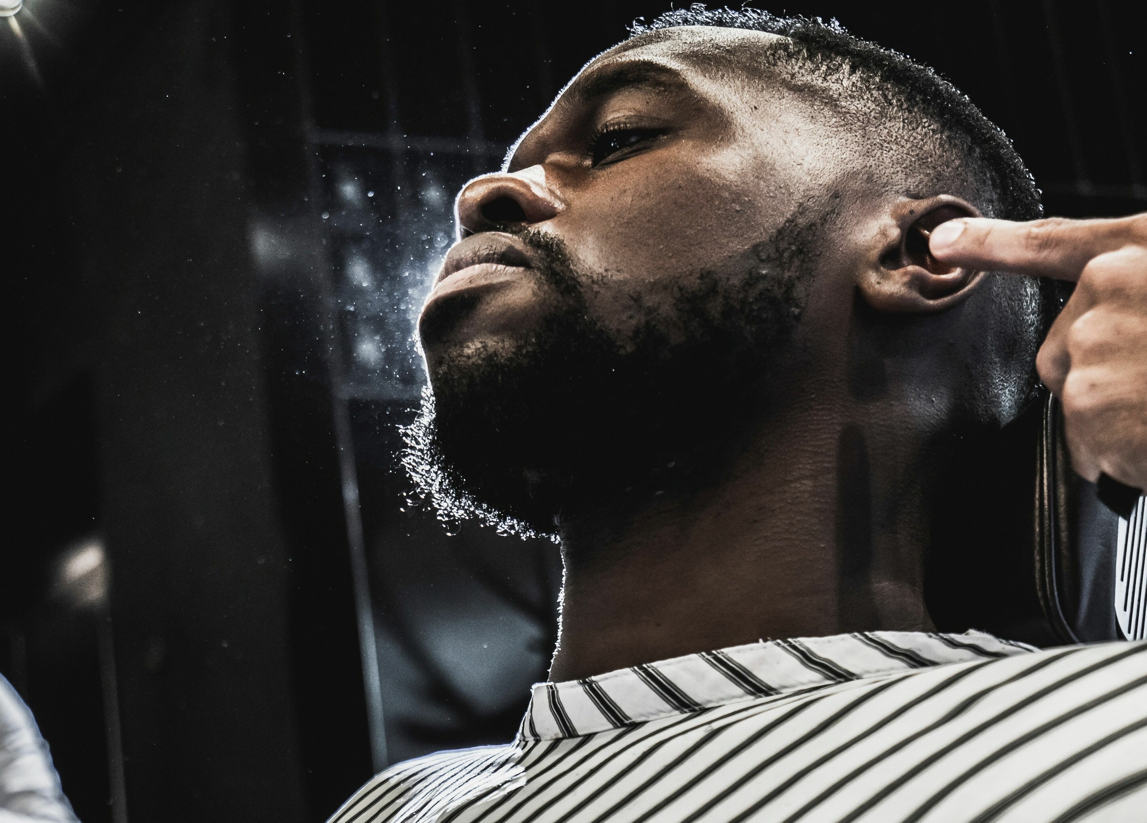 Barber providing a precise haircut at Chaps & Co - JLT, Dubai, AE, showcasing expert grooming techniques.